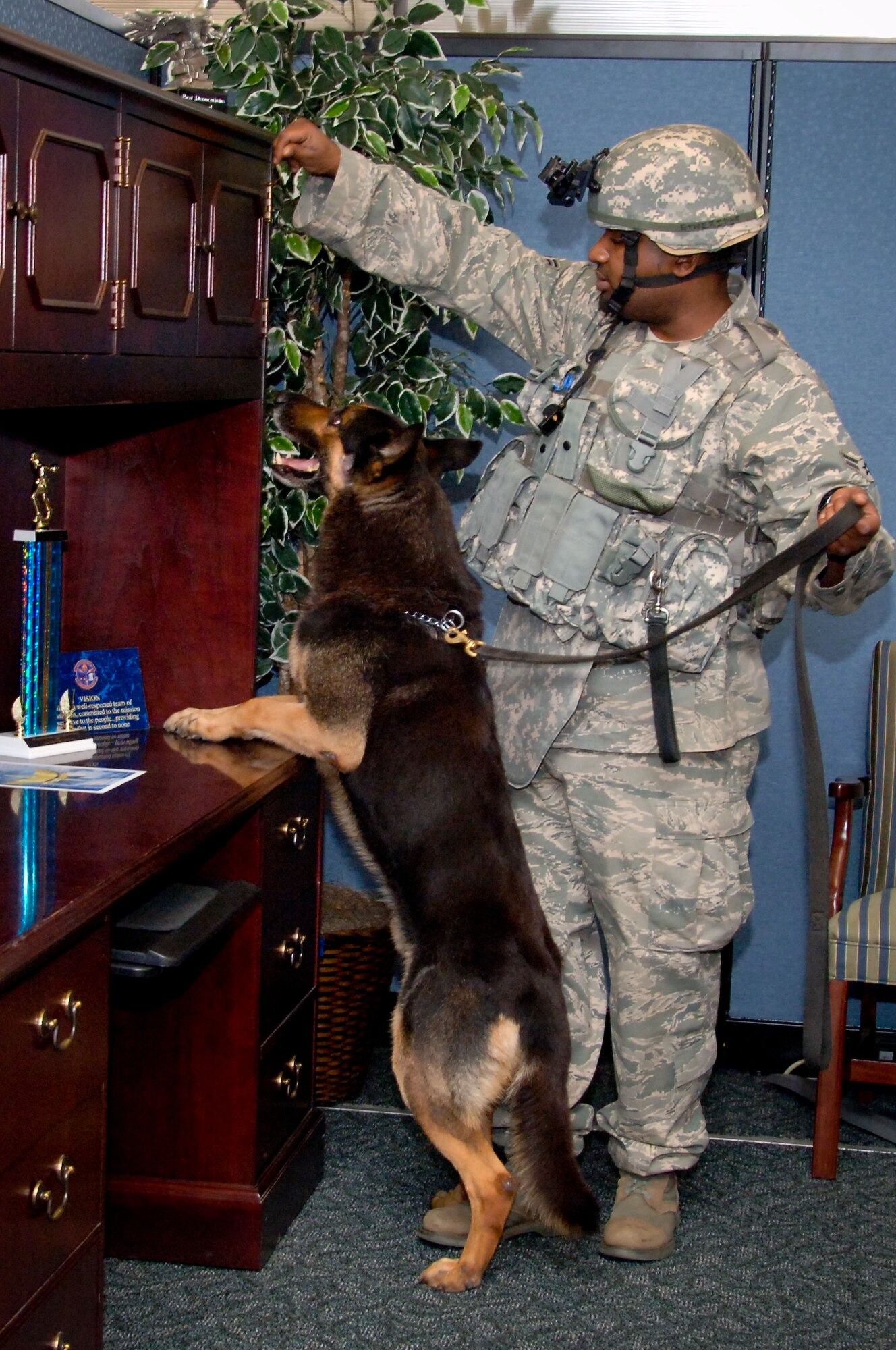 With the help of his Military Working Dog handler, Airman 1st Class Lashaun Etheridge, 42nd Security Forces Squadron MWD Nero searches Maxwell's building 804 for a bomb. (U.S. Air Force photo by Jamie Pitcher)