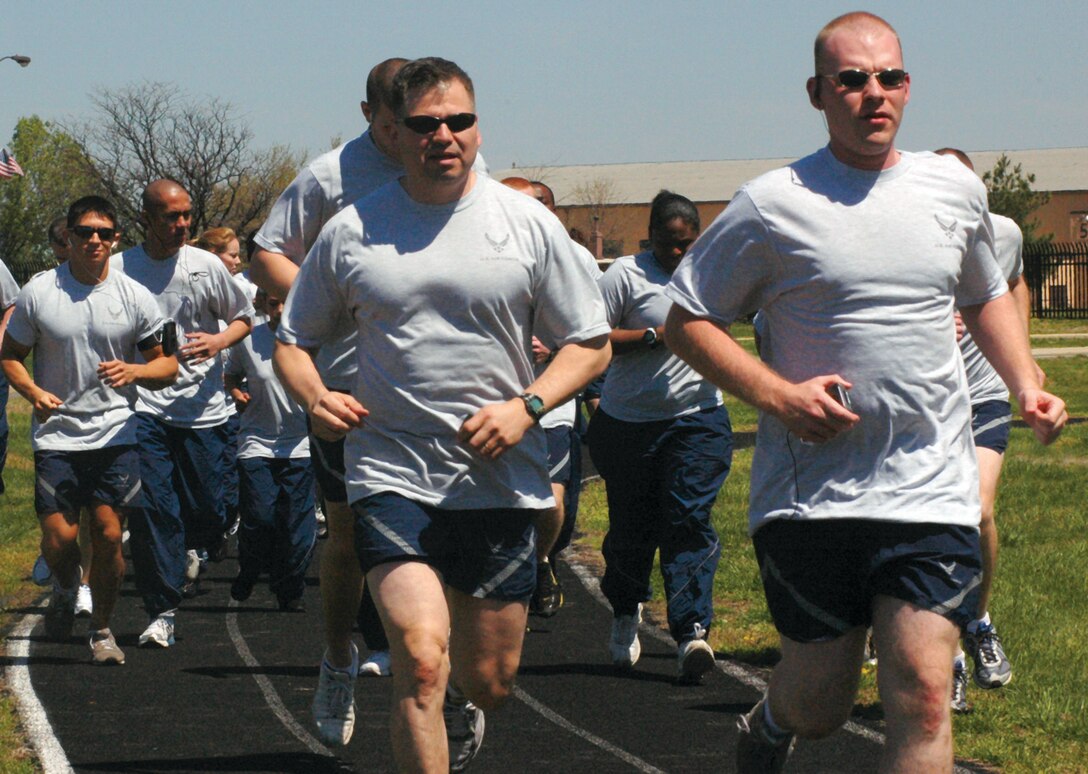 A group of 779th Medical Support Squadron members start a mile and a half run at the track near the Military Personnel Flight, Bldg. 1414, April 17. The unit performed pushups, situps and stretching exercises prior to the run. (U.S. Air Force photo/ Bobby Jones)