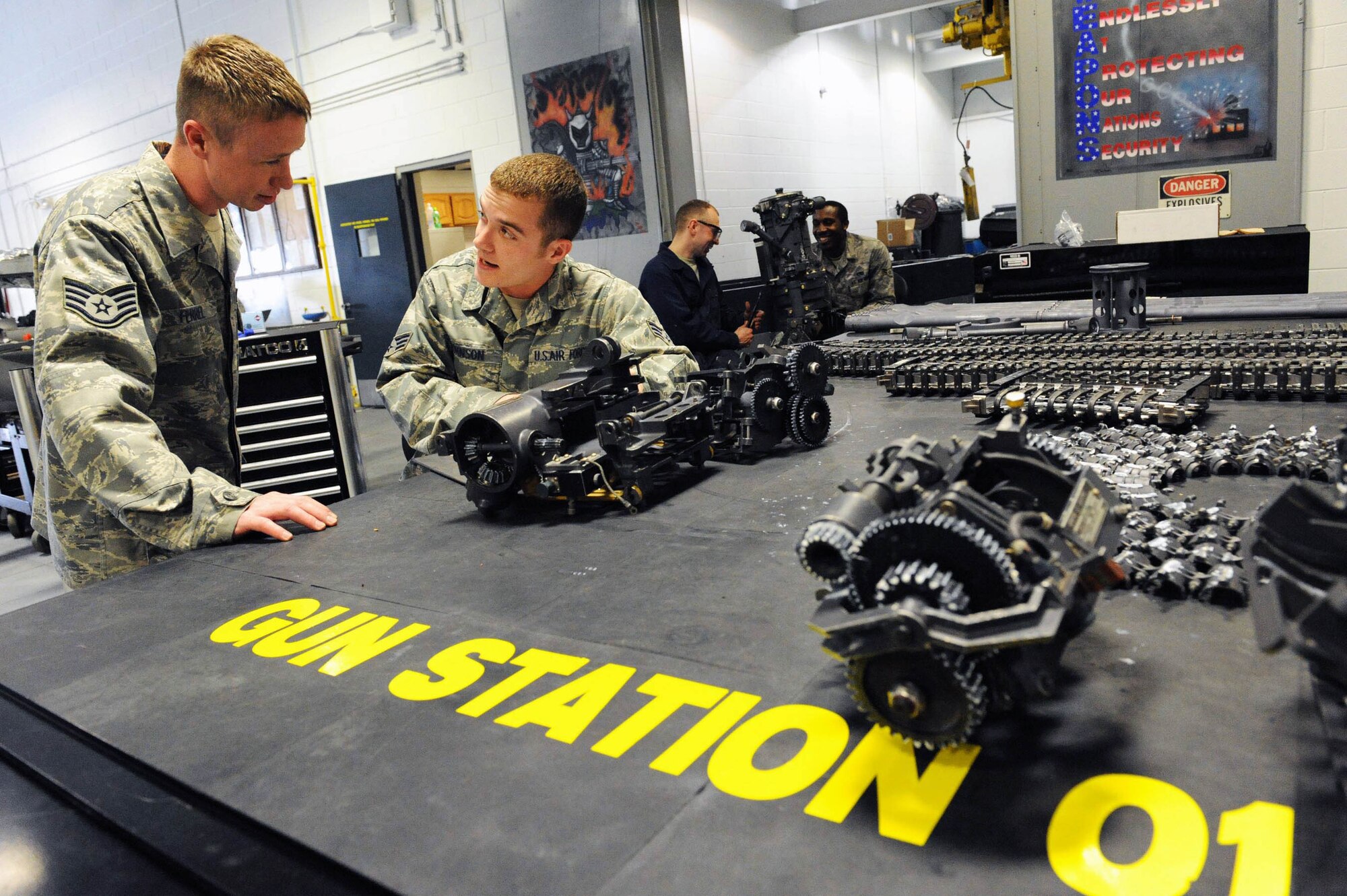 Staff Sgt. Brandon Ferrel and Senior Airman Zach Johnson rebuild the M61A1 20mm gatling gun on new gun station table created with a rapid improvement event conducted by the 20th Equipment Maintenance Squadron as Shaw Air Force Base, S.C., March 12. The RIE is part of Air Force Smart Operations for the 21st Century being implemented on Shaw AFB. Sergeant Ferrel and Airman Johnson are 20th Equipment Maintenance Squadron armament system specialists. (U.S. Air Force photo/Senior Airman Matthew Davis)