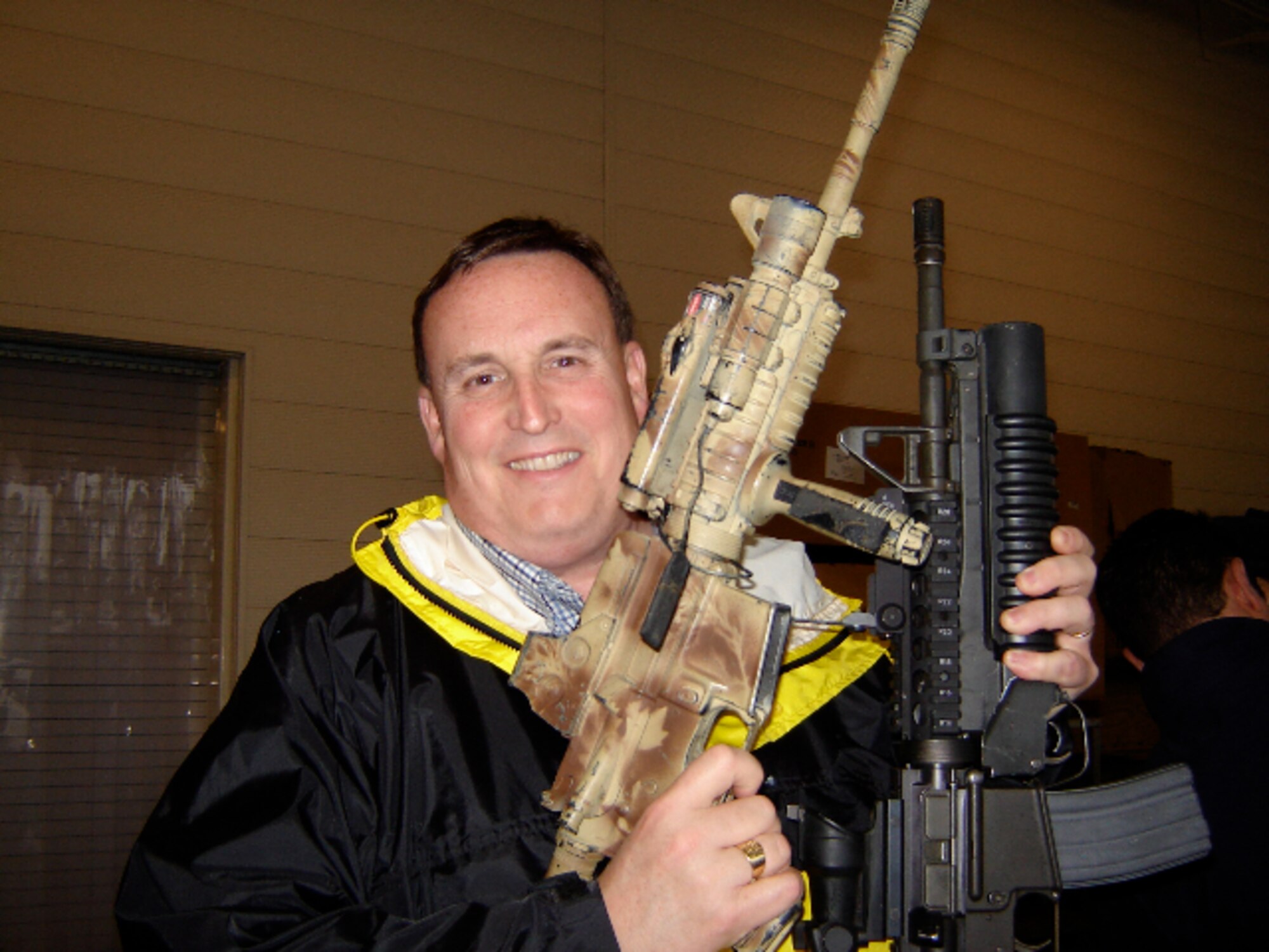 During a trip to Hurlburt Field, Fla., members of the National Security Forum Alumni Outreach program visited the Special Tactics and Training Squadron and were shown some of the equipment being used by the military today. Mark Caldwell, a former NSF attendee, enjoyed holding two of the rifles Airmen use in Southwest Asia. (Courtesy photo)