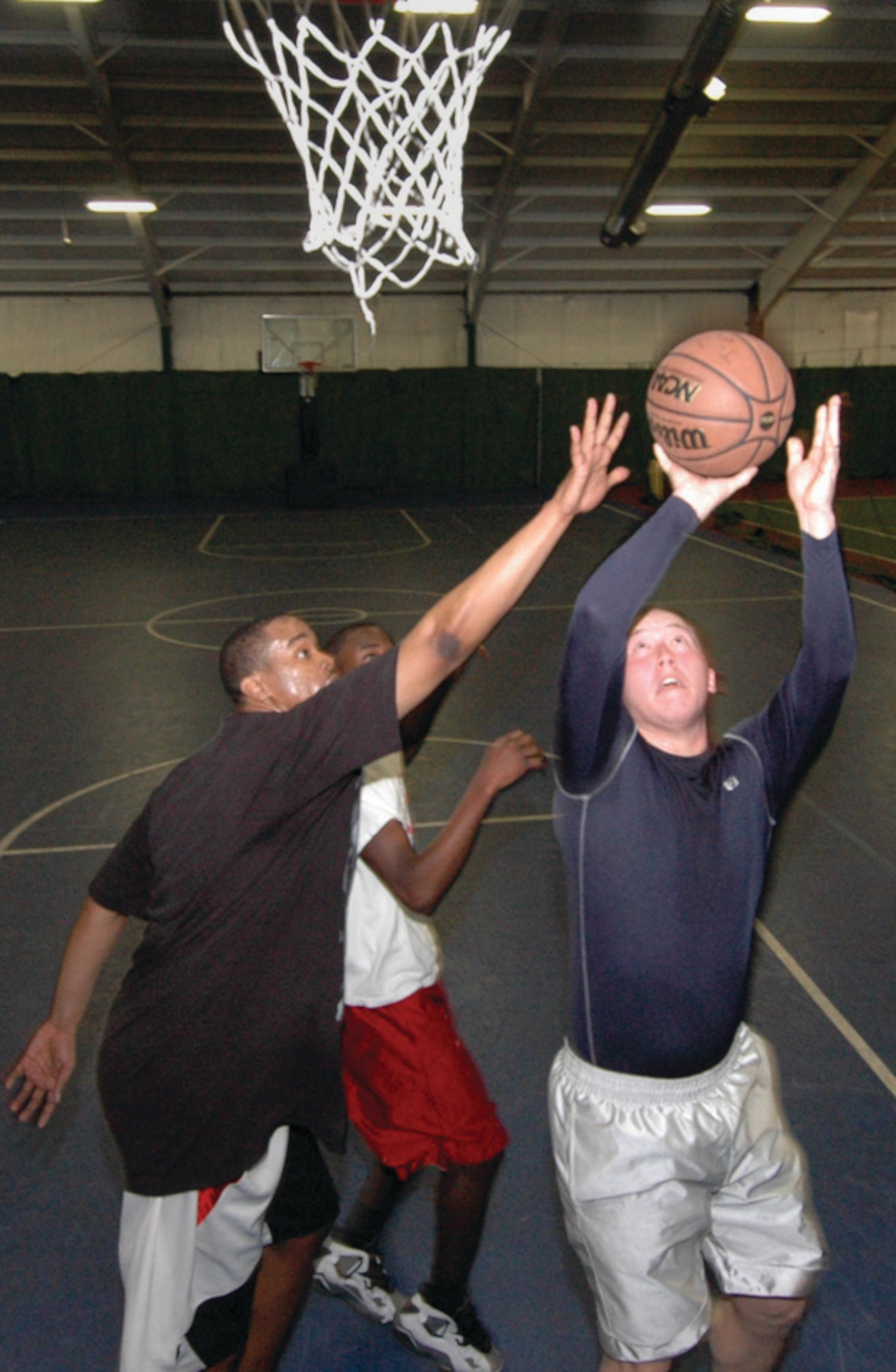 Senior Airman Joshua Harding, 779th Dental Squadron dental journeyman, left, attempts to block a shot against, Airman 1st Class Joseph McIlvaine, 779th Medical Operation Squadron diagnostic imaging apprentice, during a pick up game of basketball at the Tactical Fitness Center Tuesday. (U.S. Air Force photo/ Bobby Jones)