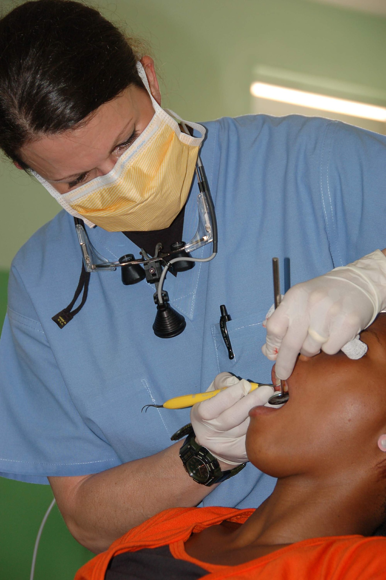 Capt. Lora R. Skeahan cleans the teeth of a patient at a primary school turned temporary clinic April 21 in Hostos, Dom. Rep., during the medical readiness exercise, Beyond the Horizon 2009 - Caribbean. The medics treated 1,800 patients during the first two days of the U.S. Southern Command sponsored MEDRETE. Captain Skeahan is a dentist from the 42nd Medical Group at Maxwell Air Force Base, Ala. (U.S. Air Force photo/Capt. Ben Sakrisson) 

