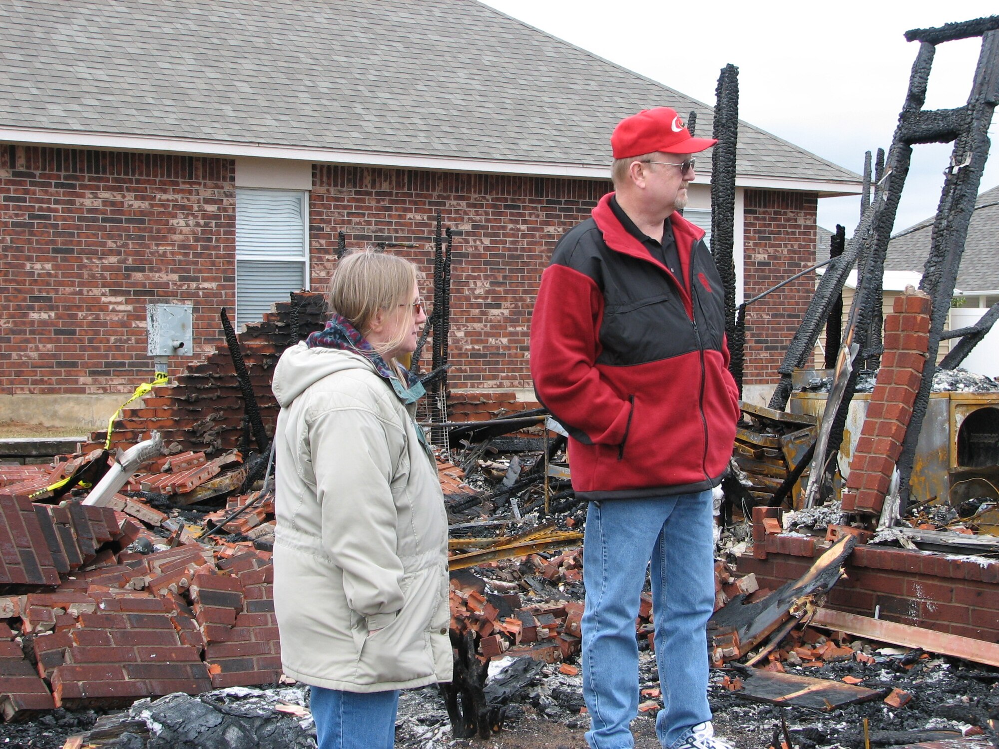 Floyd Craft, 547th Propulsion Maintenance Squadron director, and his wife, Meg Miller, stand in the burned shell of what was their home in Midwest City. After the fires, that tore through the area on April 9, several Team Tinker members were affected. The base continues to support those victims by making available food, lodging and loan items along with other services.