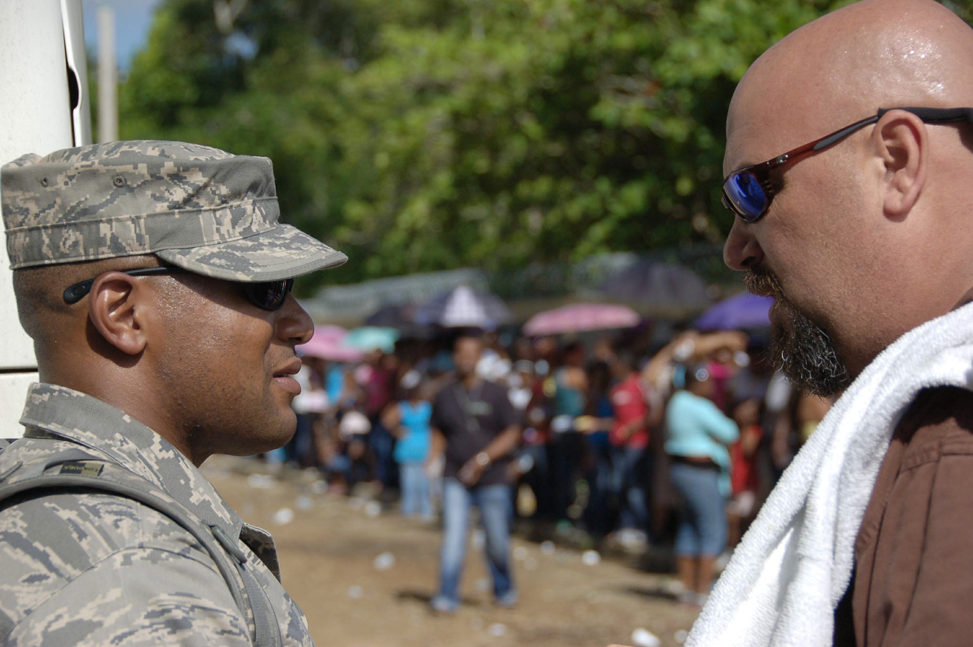 Tech. Sgt. Marcus A. Jackson (left) and John Henry discuss security April 20 as patients line up in the background at a primary school in Hostos, Dom. Rep., during the medical readiness exercise, Beyond the Horizon 2009 - Caribbean.  Mr. Henry is the mission planner of the largest Maxwell Air Force Base-planned MEDRETE to date and Sergeant Jackson is the day shift flight chief with the 42nd Security Forces Squadron at Maxwell AFB.  (U.S. Air Force photo/Capt. Ben Sakrisson) 
