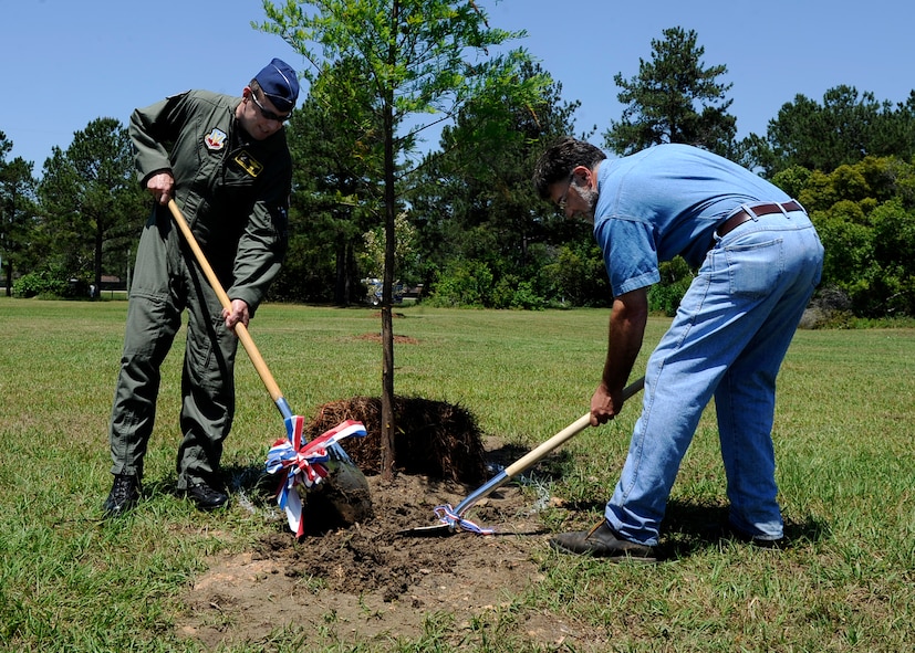 MOODY AIR FORCE BASE, Ga. -- Col. Henry Santicola, 23rd Wing vice commander, and John Crain, 23rd Civil Engineer Squadron, plant a new tree at Tree City, USA here April 23. The new tree was planted in honor of Earth Day. (U.S. Air Force photo by Senior Airman Brittany Barker)
