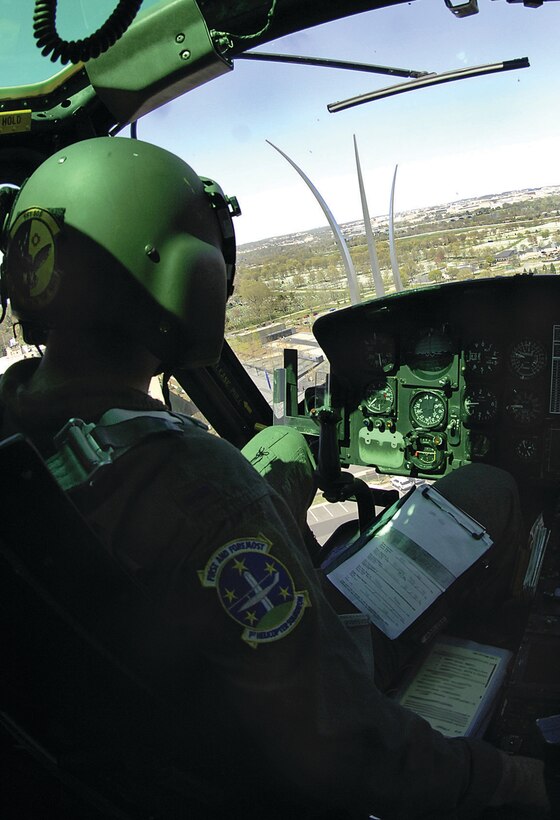 1st Lt. Theodore Rogers, 1st Helicopter Squadron pilot, flies over the Air Force Memorial in Washington D.C. April 17. The 1st Helicopter Squadron performs flying missions over D.C. to ensure the pilots have adequate training in order to be ready to respond to any possible real world scenarios at a moments notice. (U.S. Air Force photo/ Senior Airman Giang Nguyen)