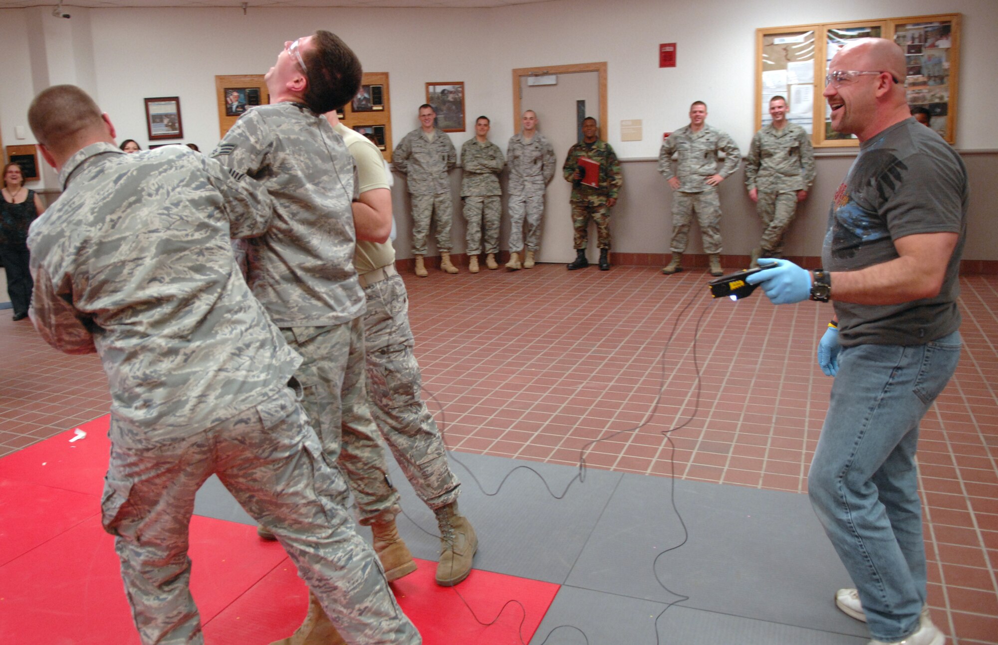 WHITEMAN AIR FORCE BASE, Mo. – Billy Matheny, 509th Security Forces Squadron, tases a training participant April 22.  The training is to certify security forces law enforcement personnel to carry and use the X26 Taser. The X26 Taser has a peak voltage of 50,000 volts of electricity and works by causing neuro-muscular incapacitation. (U.S. Air Force photo/Senior Airman Stephen Linch)