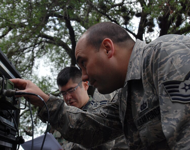Reservists from the 433rd Aeromedical Evacuation Squadron practice establishing mobile communications between two teams, in hilly terrain in wet weather. The training gave the team an opportunity to test the ability to communicate when not in each other's line of sight. Communications is an important part of any successful mission and is vital in the medical evacuation business when every minute matters. (U.S. Air Force photo/Airman Brian McGloin)