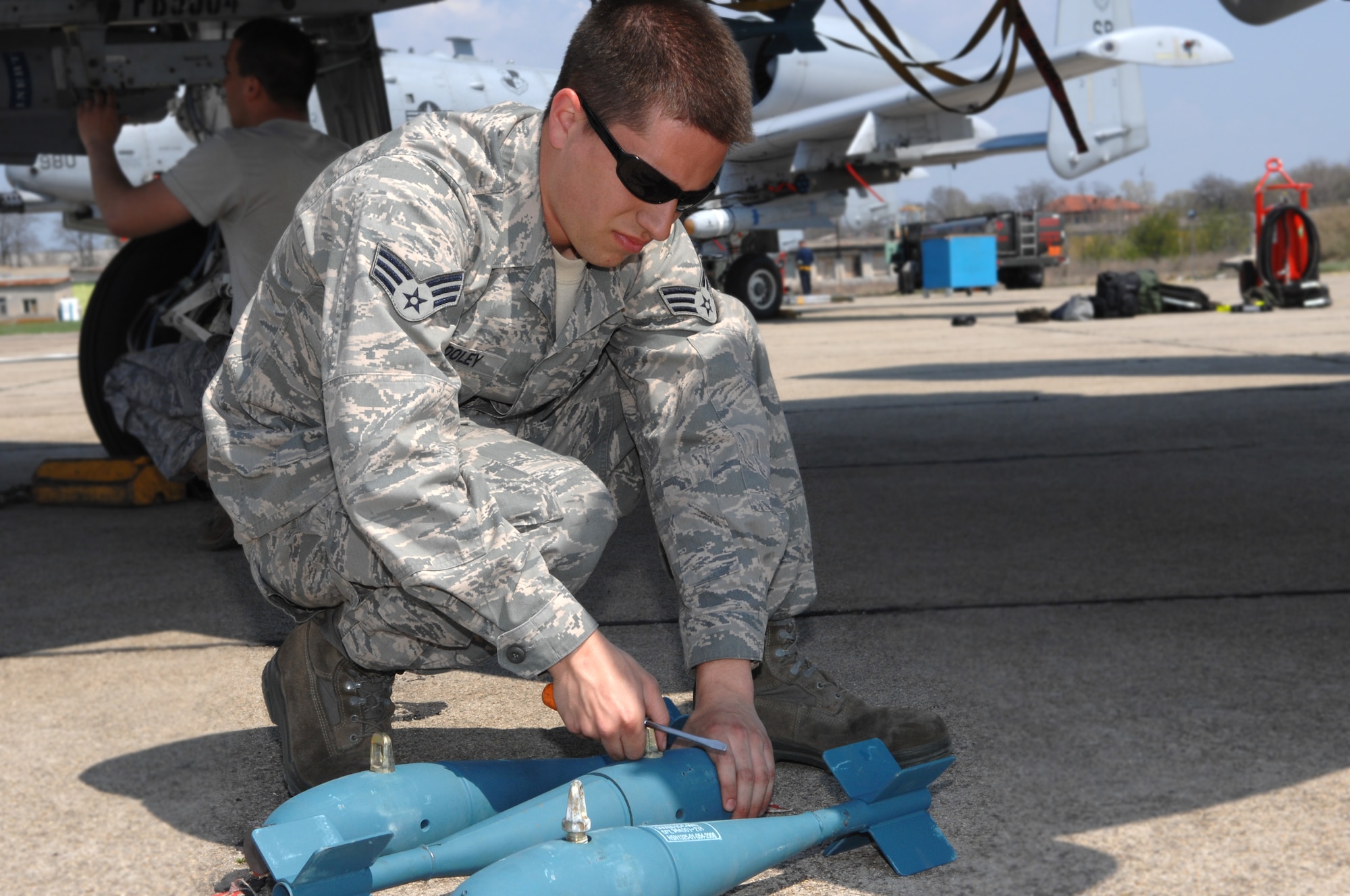 BEZMER AIR BASE, Bulgaria – Senior Airman Ryan Wooley, 52nd Aircraft Maintenance Squadron weapons load crew member, prepares BDU-33 practice bombs for loading onto an A-10 prior to a training mission.  A maintenance squadron team deployed to Bezmer Air Base, Bulgaria, to support a U.S. and Bulgarian Air Forces training exercise. (U.S. Air Force photo by Master Sgt. Bill Gomez) 