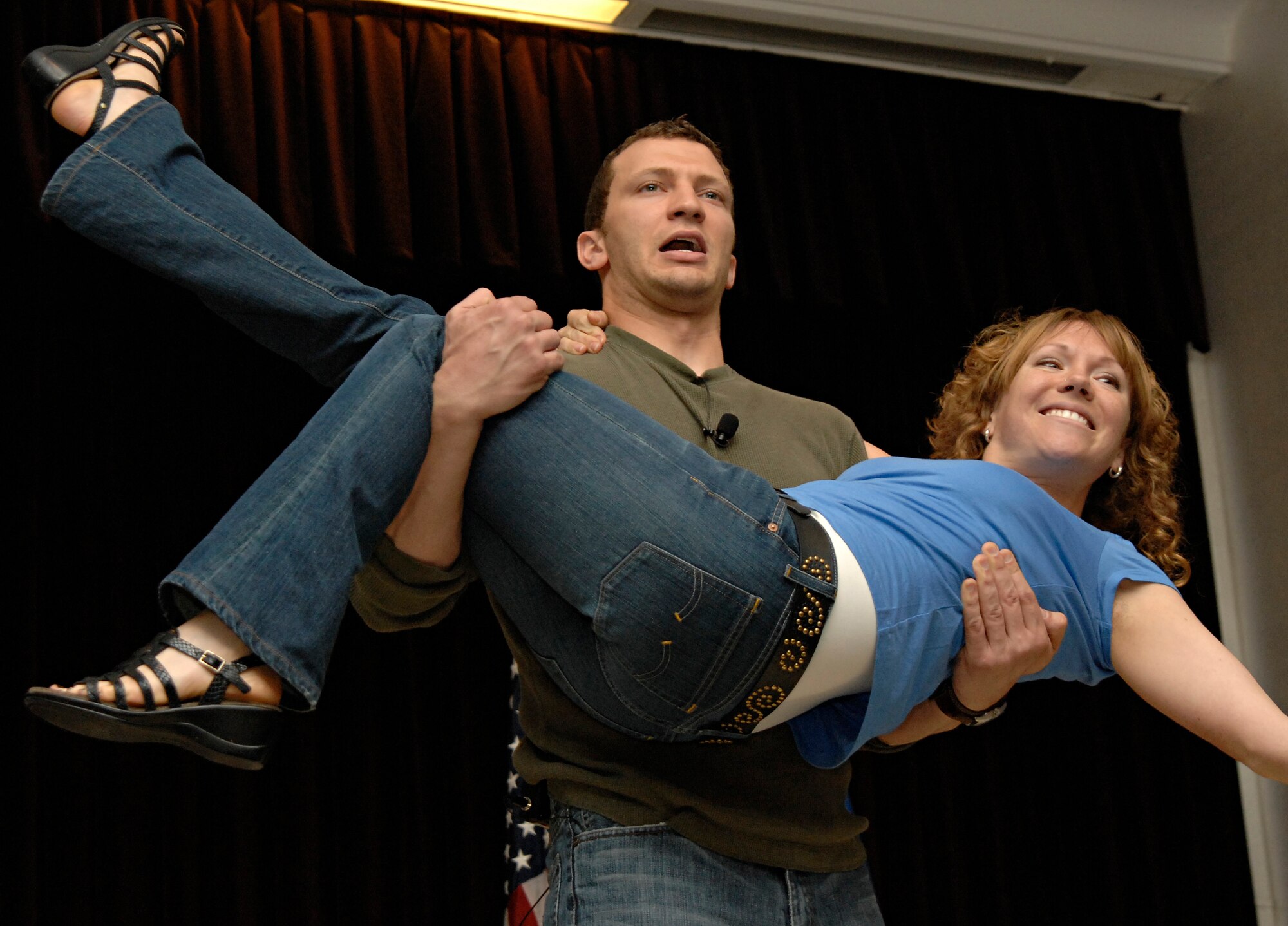 Courtney Abbott jumps into the arms of Ben Murrie, actors for Catharsis Productions, at the end of presentation entitled “Sex Signals” at the Incirlik Consolidated Club, April 23, 2009. “Sex Signals" actors demonstrate how to recognize early warning signs of relationship violence and prevent sexual assault, said Dr. Thomas Appel-Schumacher, chief of USAFE Sexual Assault Prevention and Response. "It also highlights the critical issue of consent in a sexual relationship," he said. "Audience participation is solicited and effectively brings out important points." (U.S. Air Force photo/Senior Airman Benjamin Wilson)