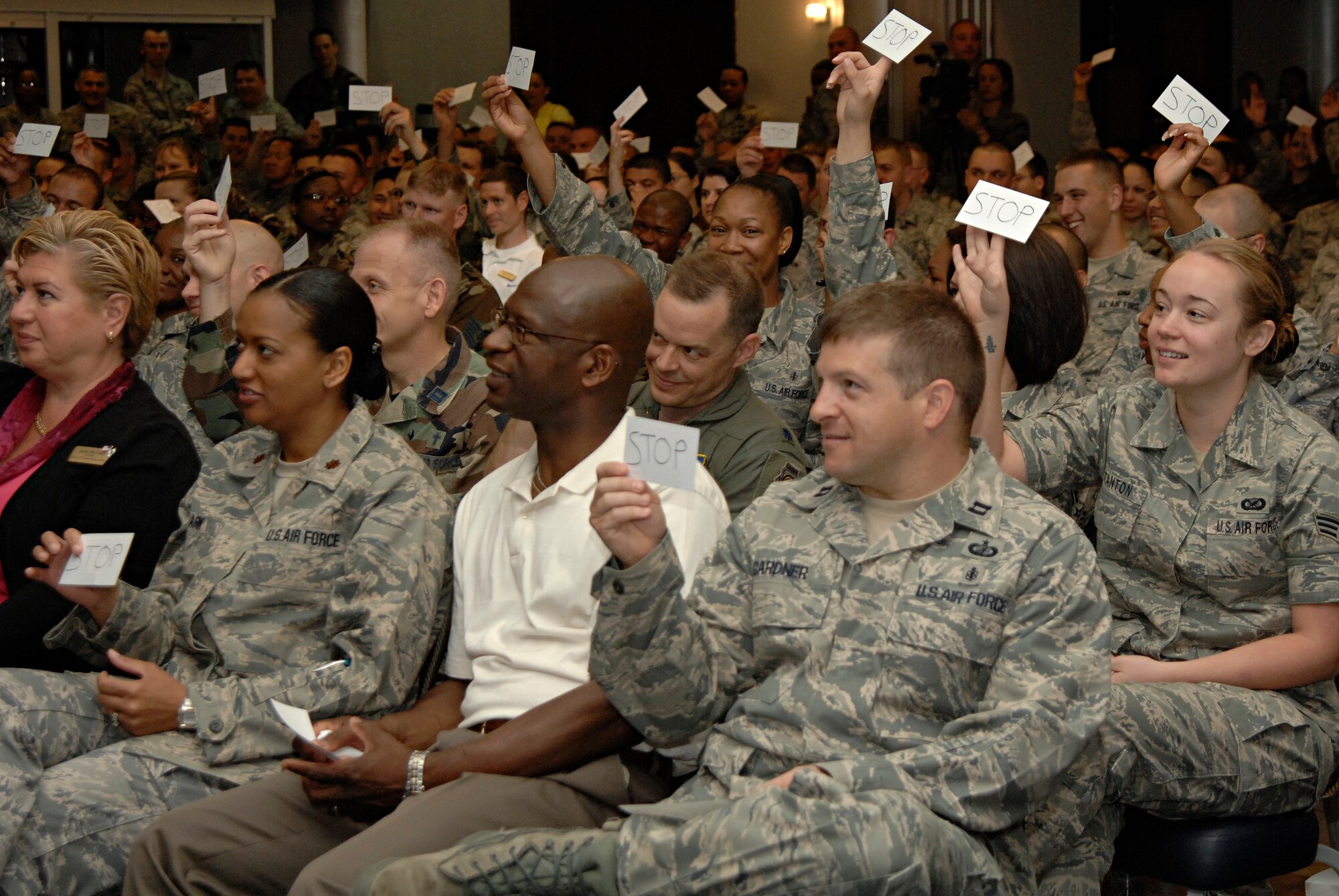 Audience members hold up “stop signs” to indicate inappropriate conduct by an actor during a presentation entitled “Sex Signals” at the Incirlik Consolidated Club, April 23, 2009. “Sex Signals" actors demonstrate how to recognize early warning signs of relationship violence and prevent sexual assault, said Dr. Thomas Appel-Schumacher, chief of USAFE Sexual Assault Prevention and Response. "It also highlights the critical issue of consent in a sexual relationship," he said. "Audience participation is solicited and effectively brings out important points." (U.S. Air Force photo/Senior Airman Benjamin Wilson)