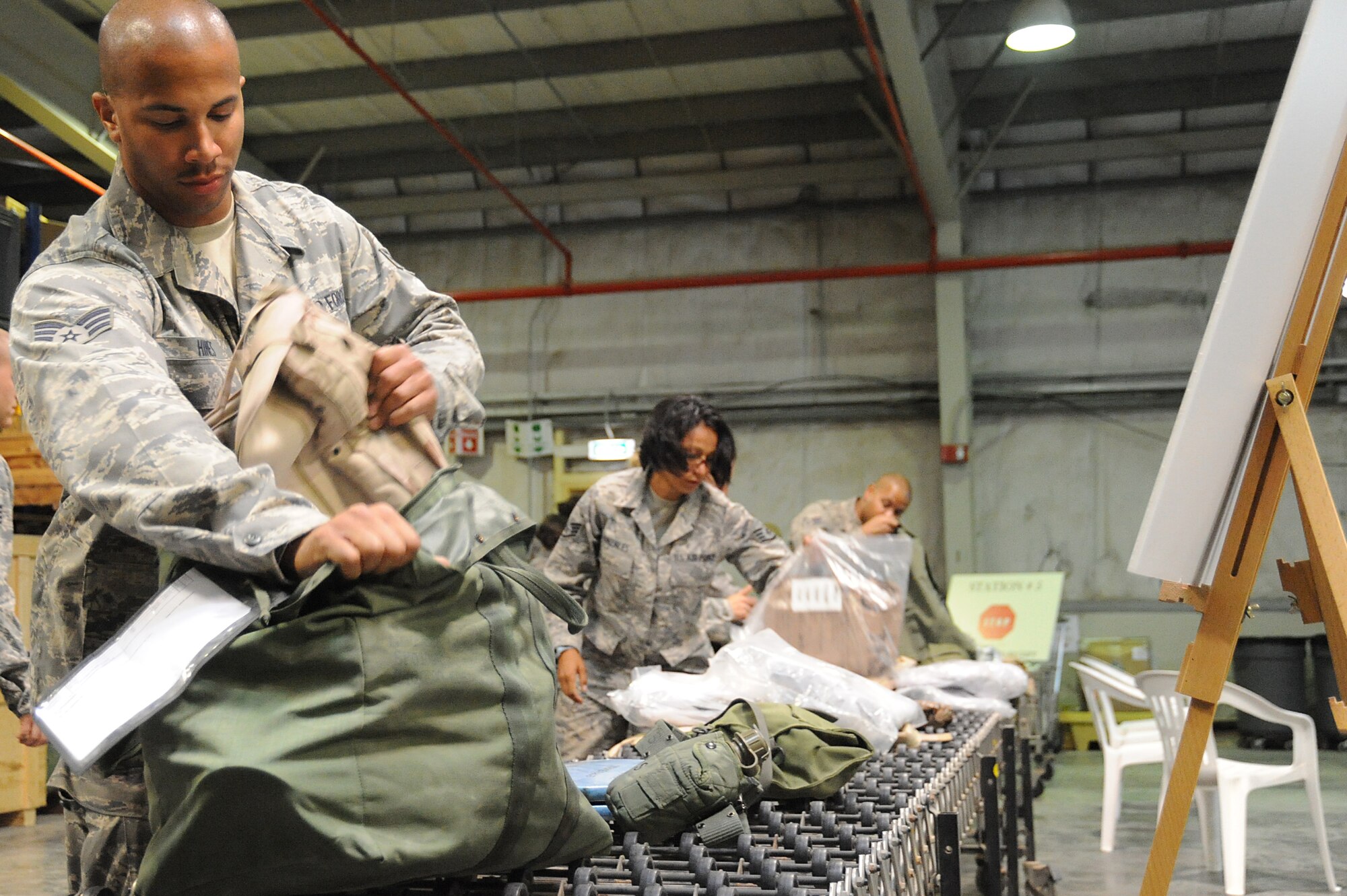 Senior Airman Ryan Hines, 380th Expeditionary Logistics Readiness Squadron, fuels maintenance, repacks his C-bag after inventorying the contents during a readiness exercise, April 21 at undisclosed location in Southwest Asia. The 380th ELRS ran a ten person exercise to test the capabilities for redeployment and will run a 100 person exercise in the coming week. Airman Hines is deployed from Nellis AFB, Nev. and is from Tampa, Fla.(U.S. Air Force photo by Senior Airman Brian J. Ellis) (Released)