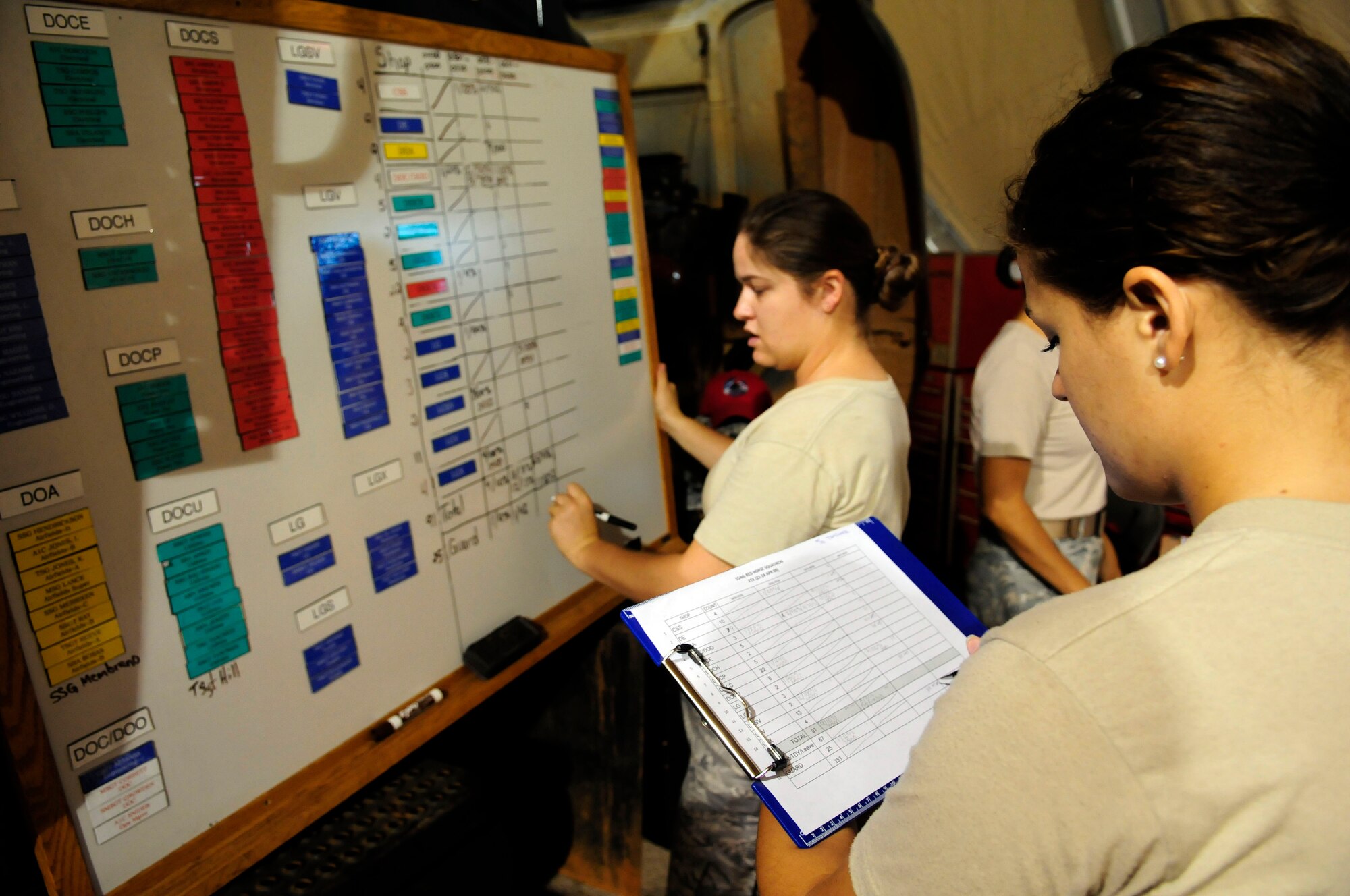 ANDERSEN AIR FORCE BASE, Guam - Airman 1st Class Savana Snider, 554th RED HORSE Operations Management, reads off the list of people that are present to Staff Sgt. Erin Aaron for accountability before starting the field training exercise out at Northwest Field April 22. The Rapid Engineer Deployable Heavy Operations Repair Squadron Engineer participated in a two day field training exercise to hone expeditionary skills to open a base in any environment. (U.S. Air Force photo by Airman 1st Class Courtney Witt)
