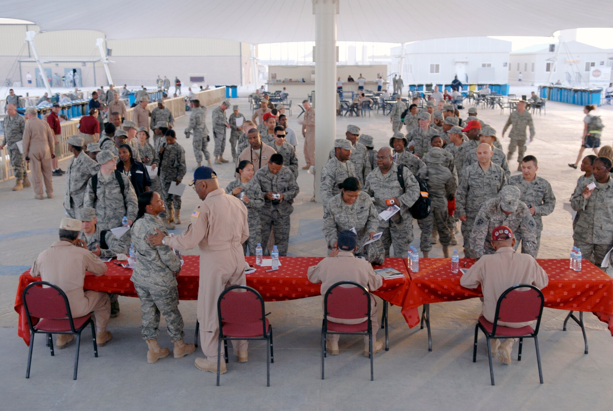 Four members of the Tuskegee Airmen sign autographs and take photos with personnel on base during their visit, Apr. 22, 2009, at an undisclosed location in Southwest Asia.  The Tuskegee Airmen toured operations and spoke with numerous personnel here supporting Operations Iraqi and Enduring Freedom and Combined Joint Task Force - Horn of Africa on base sharing their stories and history when they served in the military.  (U.S. Air Force photo/Senior Airman Andrew Satran/released)