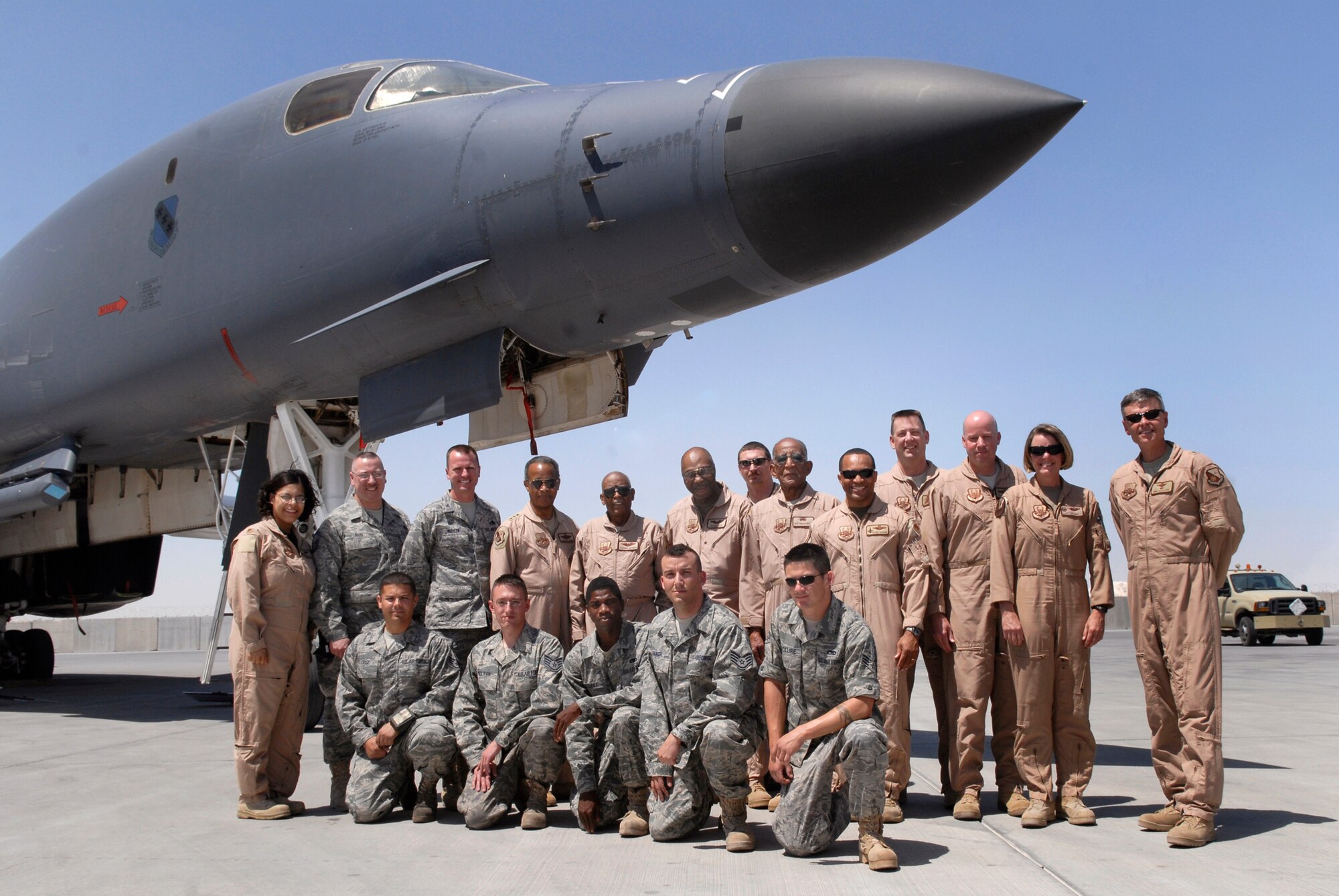 Four members of the Tuskegee Airmen pose for a photograph in front of a B-1B Lancer with the 379th Air Expeditionary Wing leadership and 9th Expeditionary Bomber Squadron members during their visit to the base, Apr. 22, 2009, at an undisclosed location in Southwest Asia.  The Tuskegee Airmen toured operations and spoke with numerous personnel here supporting Operations Iraqi and Enduring Freedom and Combined Joint Task Force - Horn of Africa, sharing their stories and history when they served in the military.  (U.S. Air Force photo/Senior Airman Andrew Satran/released)