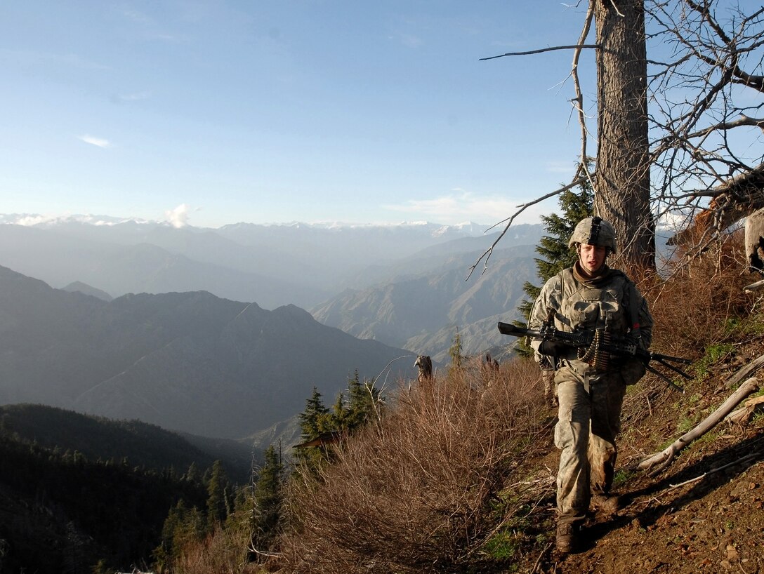U.S. Army Spc. Andrew Harvey trudges across the steep cliff sides surrounding Korengal Valley, Afghanistan, during Operation Viper Shake, April 21, 2009. During the operation, soldiers from the 1st Infantry Division's Company C, 1st Battalion, 26th Infantry Regiment, hiked to elevations of more than 2,500 meters to disrupt violent extremists operating in one of Afghanistan’s most hostile areas.
