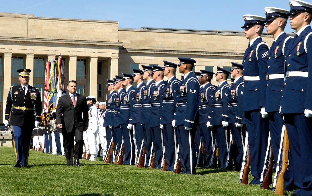 U.S. Army Col. Joe Buche, commander of the the 3rd Infantry Regiment, left, escorts King Abdullah II of Jordan down a line of troops for inspection during a joint service, full honors ceremony at the Pentagon, April 24, 2009.