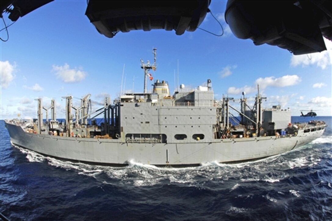 A U.S. Navy MH-60S Sea Hawk helicopter lifts cargo from the flight deck of USNS San Jose during a replenishment at sea with aircraft carrier USS John C. Stennis in the Pacific Ocean, April 18, 2009. The USS Stennis is on a scheduled six-month deployment to the western Pacific.