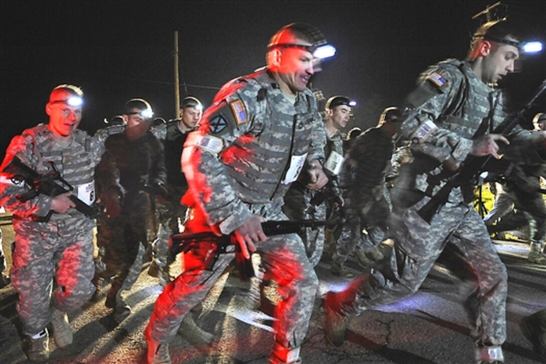 U.S. Army soldiers begin a three-mile buddy run while geared in Kevlar and flak jackets during phase one of the physical training test for the 2009 Best Sapper Competition on Fort Leonard Wood, Mo., April 20, 2009. The annual competition, which consists of six phases over 52 hours, is held for combat engineers to compete for the title of Best Sapper.