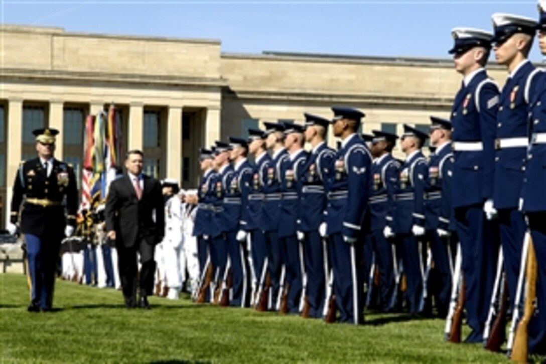 U.S. Army Col. Joe Buche, left, commander of the 3rd Infantry Regiment, escorts King Abdullah II, ruler of the Hashemite Kingdom of Jordan, down a line of troops for inspection during a joint service, full honors ceremony at the Pentagon, April 24, 2009.