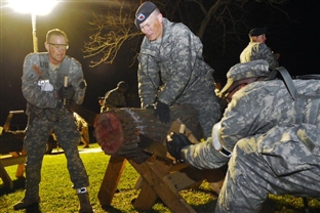 U.S. soldiers race to the second event, the log cut and carry, in the sixth and final phase of the 2009 Best Sapper Competition on Fort Leonard Wood Missouri, April 20, 2009.