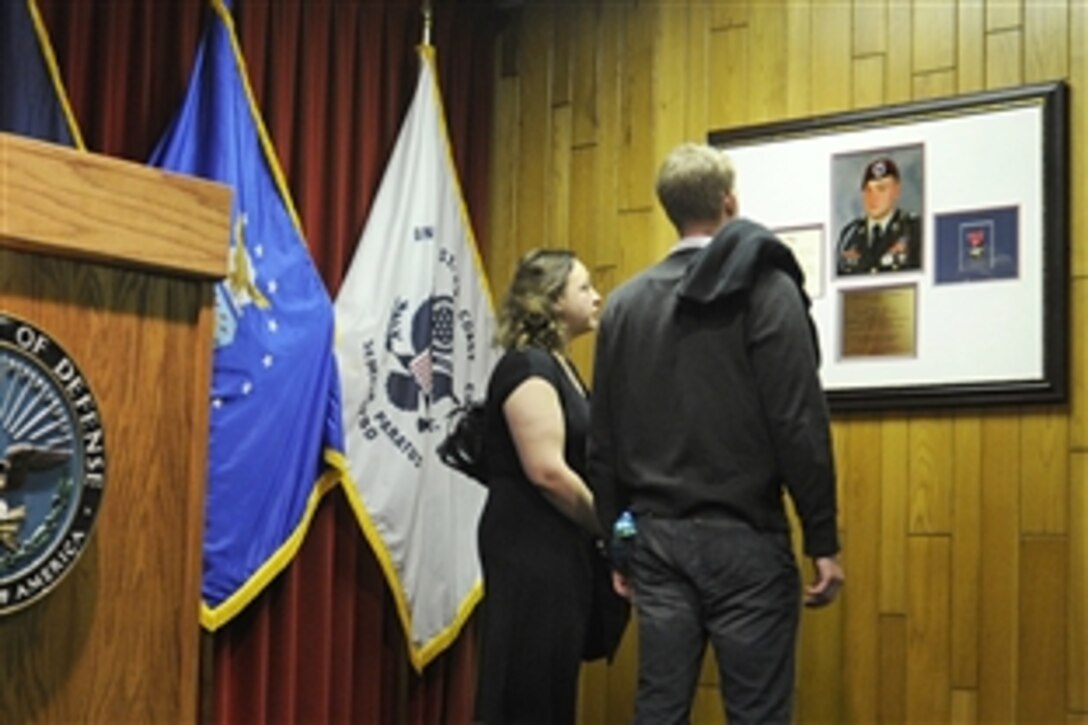Ann Vanek, left, sister of U.S. Army Sgt. Joe Vanek, and a family friend reflect beneath a plaque in Sgt. Vanek's honor in the Joseph M. Vanek Ceremony Room at the Chicago Military Entrance Processing Station, April 20, 2009. Vanek, an infantry squad leader, was killed in Iraq in 2007, and the room where recruits swear their oath of allegiance was renamed in his honor. His unit was the 82nd Airborne Division's Company C, 2nd Battalion, 325th Airborne Infantry Regiment.