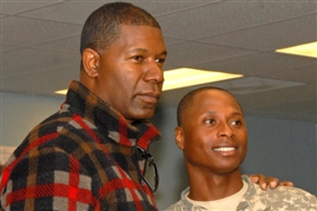 Actor Dennis Haysbert, cast member of the television series, "The Unit," poses for a photo with U.S. Army Warrant Officer Levar Gillie during a USO Spring Troop visit to Forward Operating Base Fenty, Afghanistan, April 23, 2009. Gillie is assigned to the 1st Infantry Division's 3rd Brigade Combat Team.