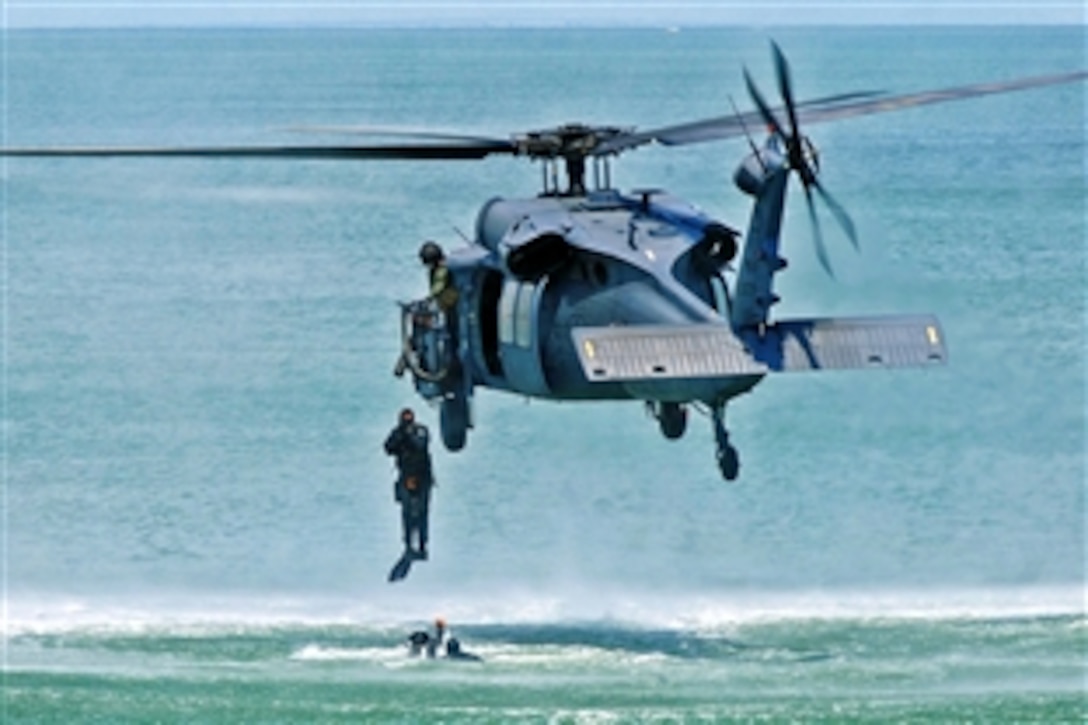 U.S. Air Force pararescuemen jump from the 41st Rescue Squadron's HH-60G Pave Hawk helicopter during the Joint Air Power Demonstration at the Virginia Beach boardwalk, Virginia Beach, Va., April 22, 2009. The pararescuemen are assigned to the 38th Rescue Squadron, Moody Air Force Base, Ga. The demonstration showcased the critical role air power plays in the joint fight and is one of many events going on during Hampton Roads Air Force Week.