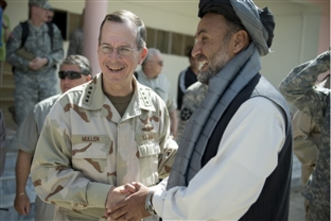 U.S. Navy Adm. Mike Mullen, chairman of the Joint Chiefs of Staff, bids farewell to the Zabul provincial governor Mohammad Ashraf Naseri after a meeting where they discussed the situation and needs in the province, Qalat, Afghanistan, April 24, 2009.