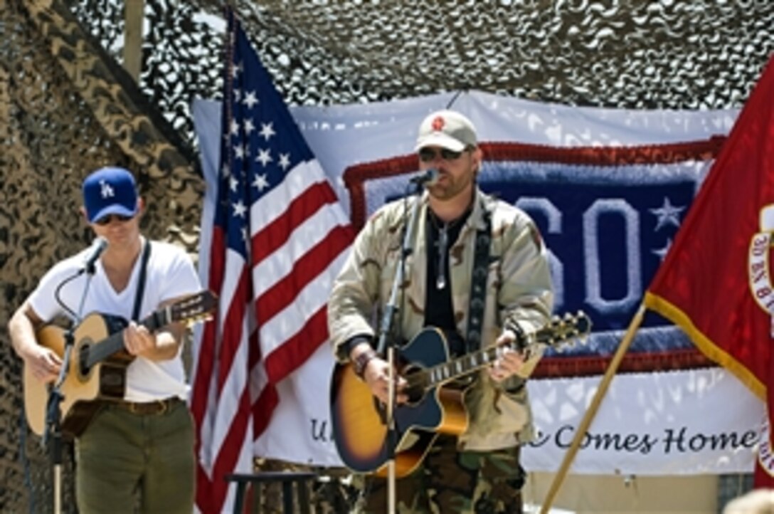 Toby Keith performs at a Forward Operating Base in Afghanistan, April 23, 2009, during his seventh USO Tour visiting America's troops. The country music mega star is performing 17 shows in 10 days as part of a USO/Armed Forces Entertainment tour. See more tour photos and read a daily blog sent in by USO's Amy Mitchell. 
