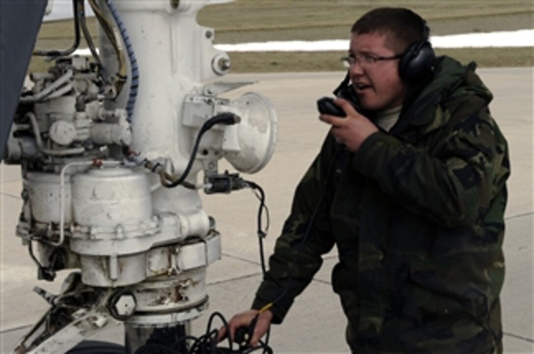 U.S. Air Force Senior Airman Chris Lee, a crew chief with the 28th Maintenance Squadron, communicates with the flight crew of a B-1B Lancer aircraft at Ellsworth Air Force Base, S.D., on April 17, 2009.  