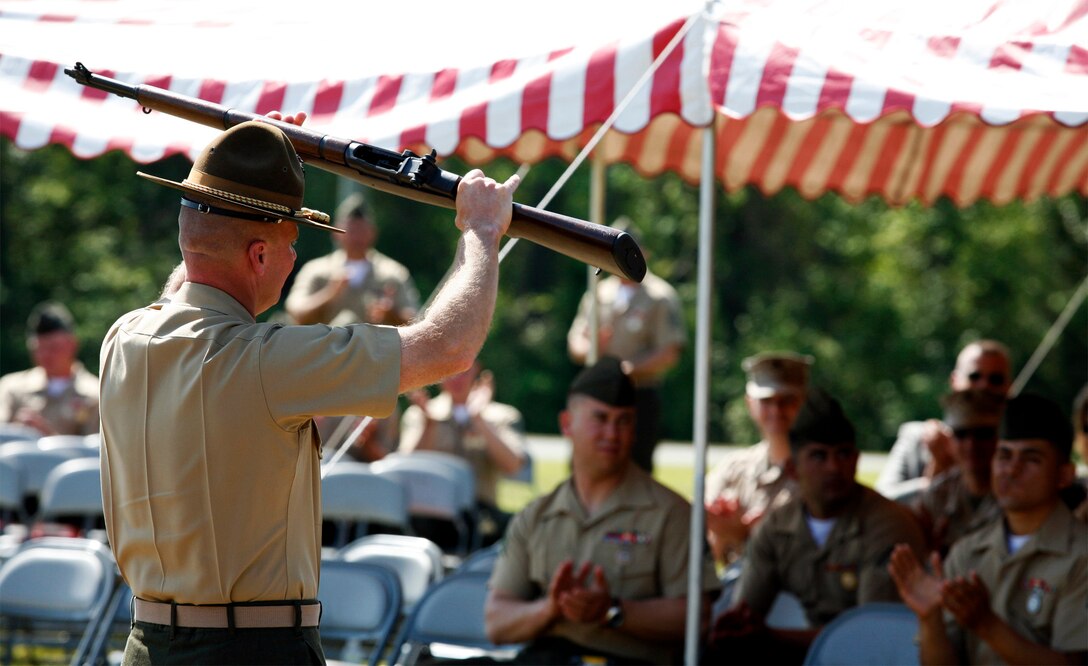 A Marine holds a Secretary of the Navy Trophy Rifle in celebration during the 2009 Marine Corps Rifle and Pistol Matches awards ceremony April 24. A small percentage of winners will be selected to represent the Marine Corps at the Inter-Service Championships and the National Matches as members of the Marine Corps Shooting Team.