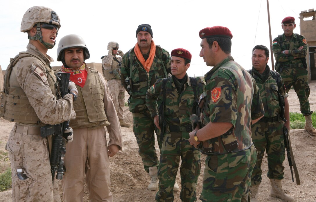 1st Lt. Blaine Barby, a platoon commander with 3rd Light Armored Reconnaissance Battalion, talks with Kurdish soldiers during a visit to Rafiyah, Iraq, April 25, 2009.  Barby says that his platoon tries to get to know the people living in the areas where they conduct most of their operations.