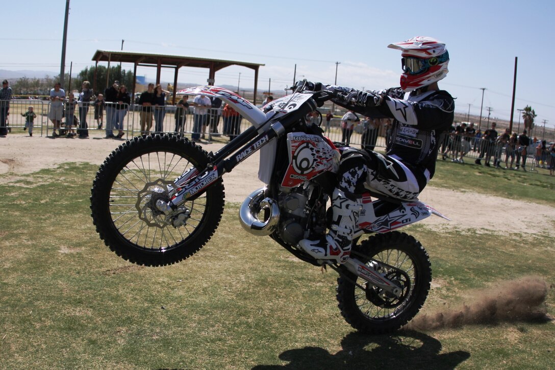 A rider with the Riders For Christ motocross team pops a wheelie during a race held at Victory Field April 25 during The Few, The Proud, The Xtreme.