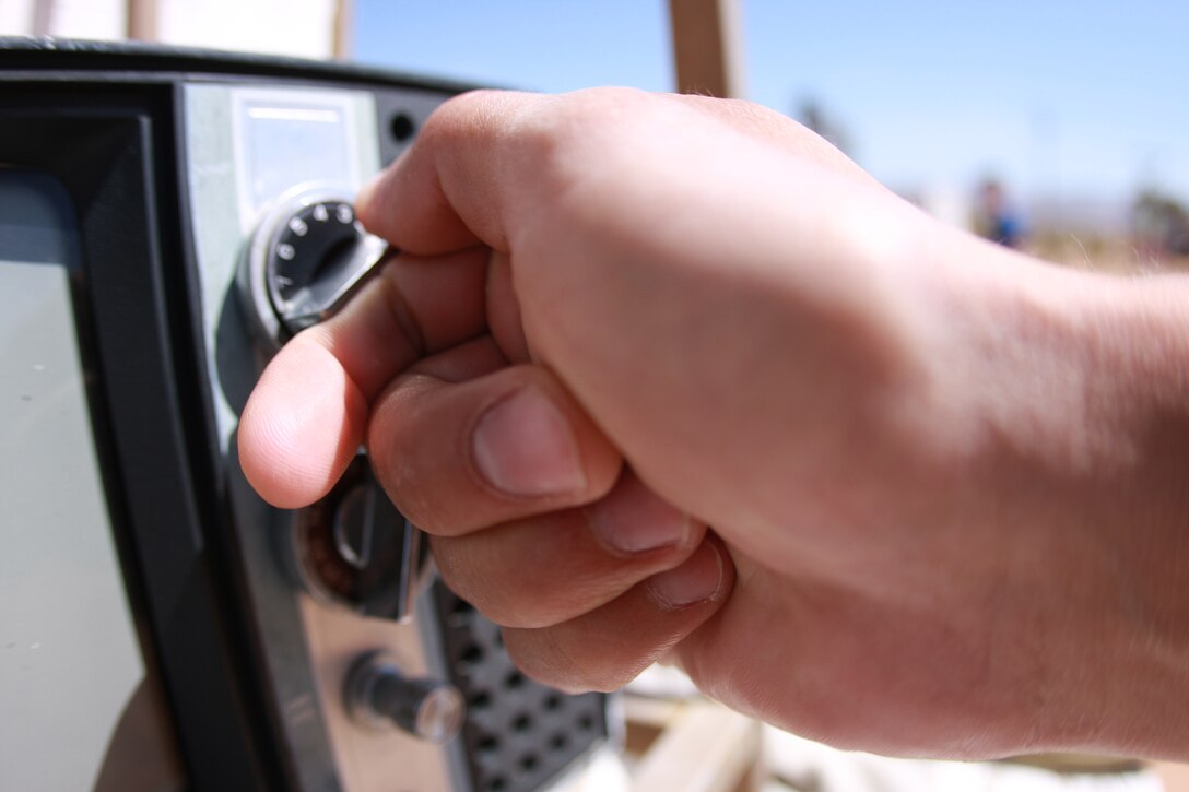Lance Cpl. Aaron Kristopik, a paralegal clerk with the Combat Center’s Staff Judge Advocate and a native of New Britain, Conn., turns the knobs on a television in one of the exhibits at the Noah Purifoy Outdoor Museum in Joshua Tree, Calif., April 25.