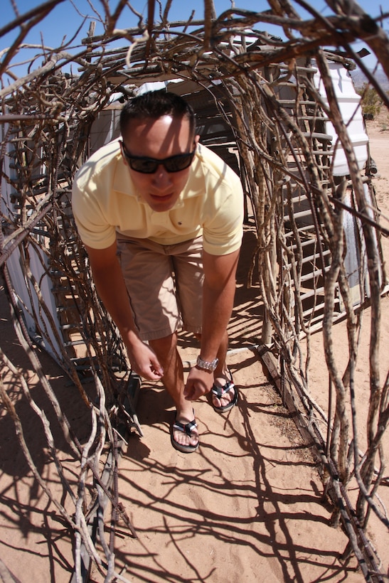 Lance Cpl. Aaron Kristopik, a paralegal clerk with the Combat Center’s Staff Judge Advocate and a native of New Britain, Conn., maneuvers down a hallway made of sticks at the Noah Purifoy Outdoor Museum in Joshua Tree, Calif., April 25.