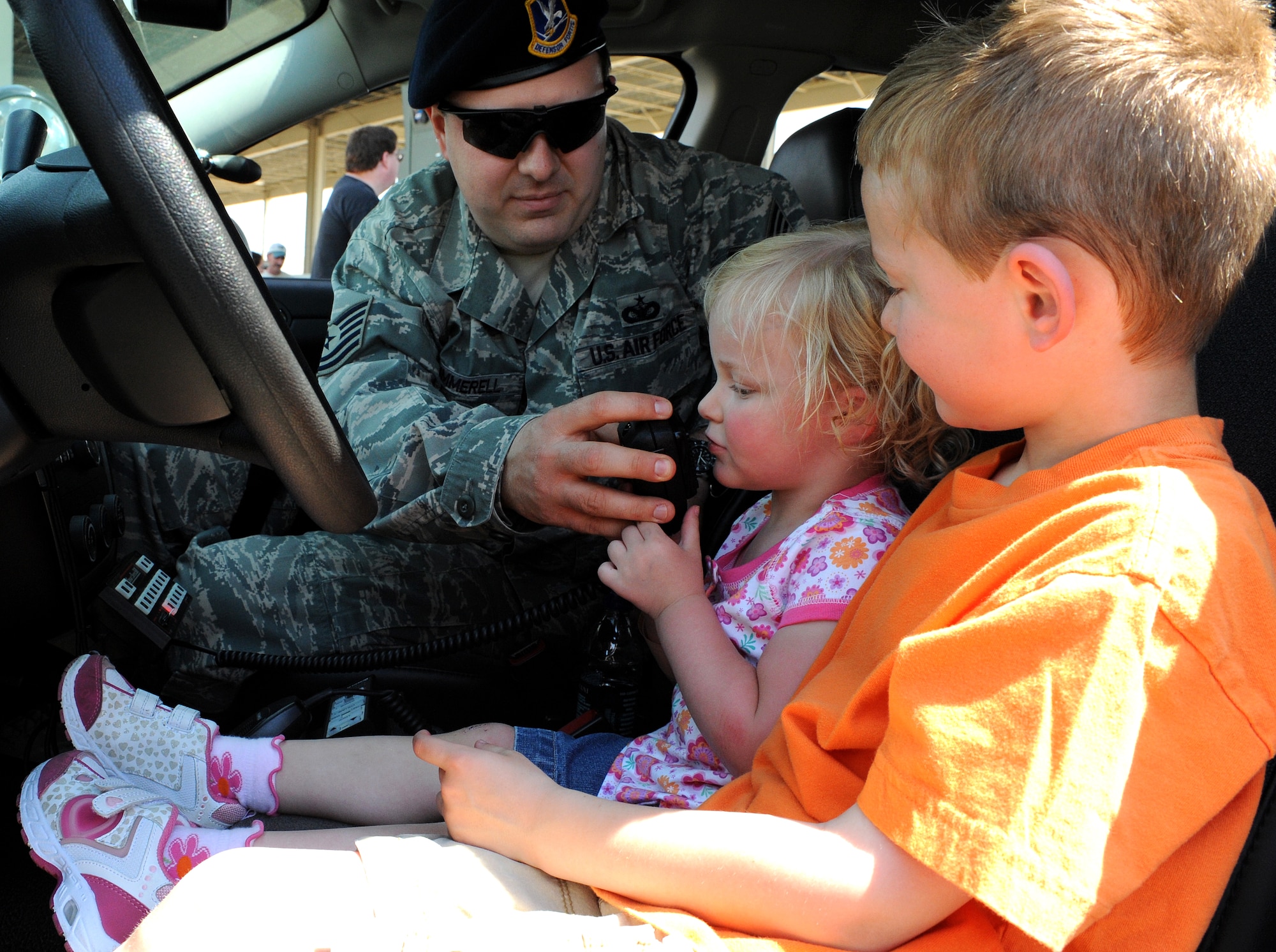 LANGLEY AIR FORCE BASE, Va. - Tech. Sgt. Daniel Summerell, 1st Security Forces Squadron, shows Simon and Suzanne Parnell how to use a megaphone during the AirPower over Hampton Roads April 25. Langley's open house helps educate the public on Air Force capabilities and show appreciation to the local community. (U.S. Air Force photo/Airman 1st Class Gul Crockett) 
