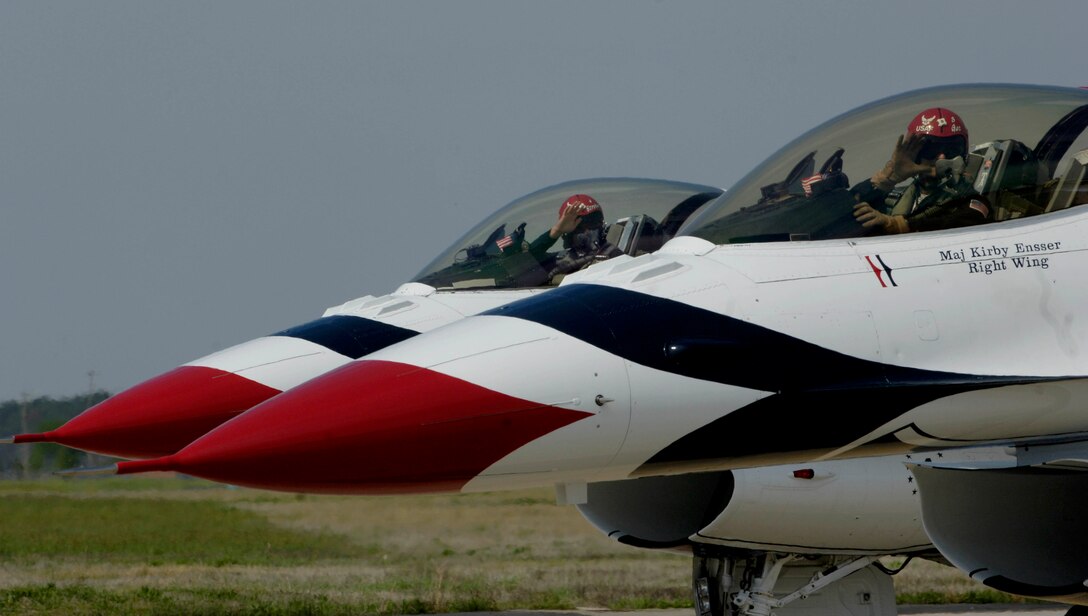 LANGLEY AIR FORCE BASE, Va. -- Majors Kirby Ensser and Sean Gustafson, Thunderbird Pilots, wave to the crowd prior to their performance during AirPower over Hampton Roads April 25. This annual event helps educate the public on Air Force capabilities and show appreciation to the local community. (U.S. Air Force photo/Airman Rebecca Montez)