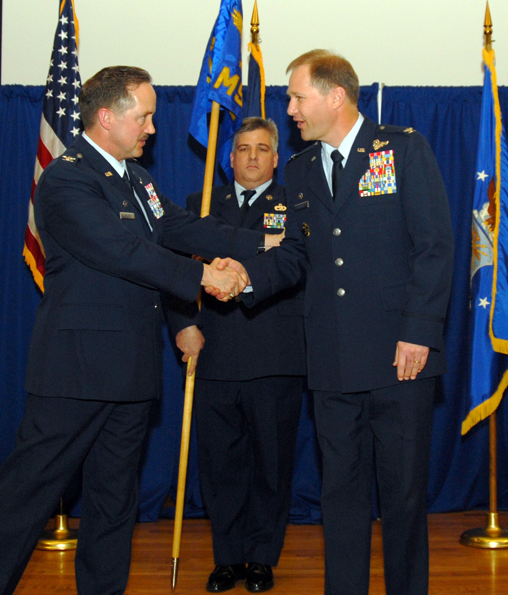 Col. Steven Bullard, right, is congratulated by Col. Greg Nelson, wing commander, after taking charge of the 123rd Mission Support Group. Colonel Bullard, a traditional guardsman, has extensive leadership in federal, state and expeditionary environments. (USAF photo by Tech. Sgt. Dennis Flora.)