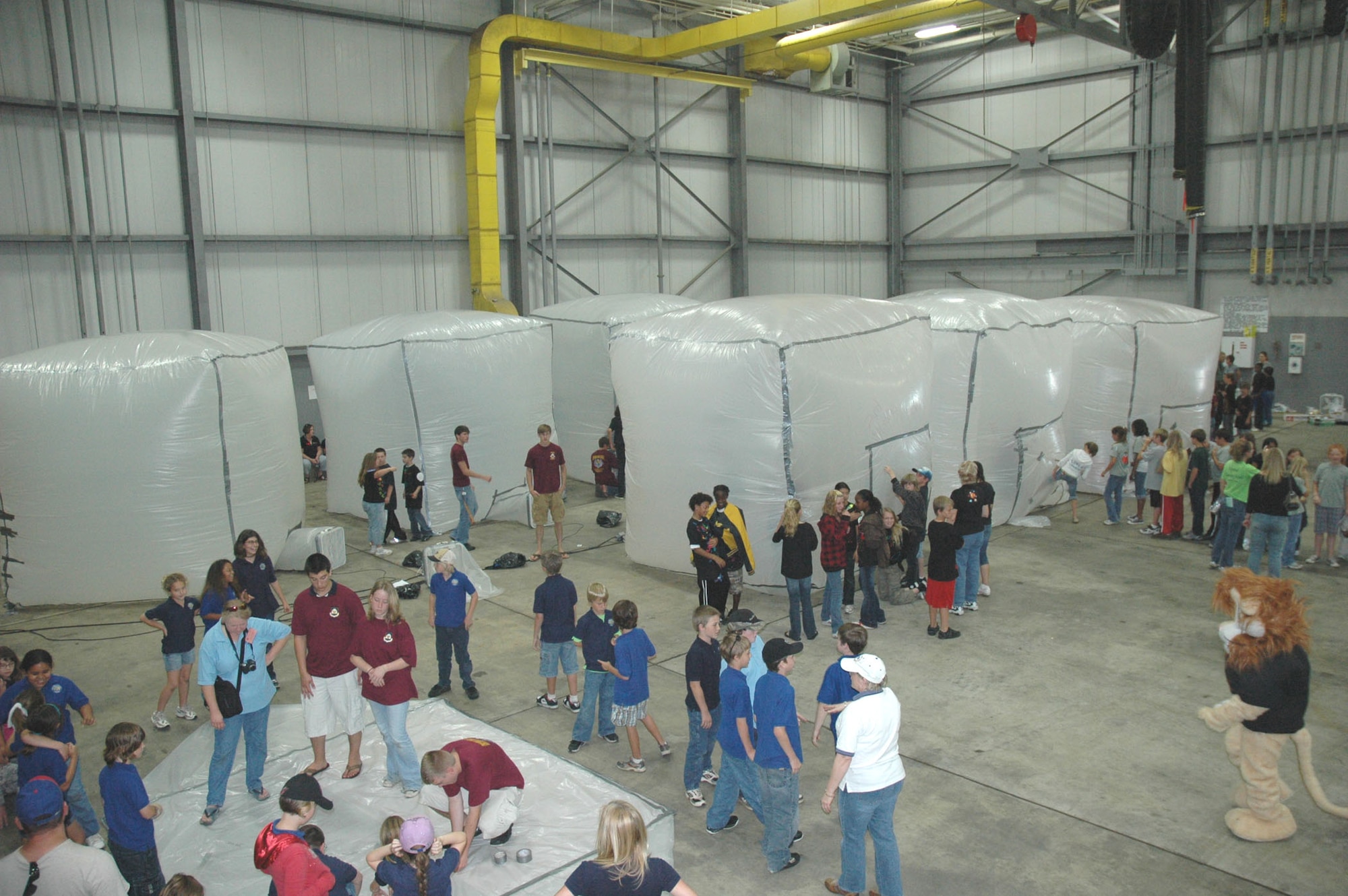 DUKE FIELD, Fla. -- Fifth-grade students from three area elementary schools transformed Duke Field's fuel cell hangar into a Martian habitat Friday during their Marsville event.  After hangar space at Eglin Air Force Base became temporarily unavailable, the 919th Special Operations Wing invited the program's host 96th Air Base Wing to use their hangar space.  More than 250 students, faculty and volunteers established a Martian base in the scientific project that challenged the youths' creativity and imagination in finding ways to colonize the Red planet with limited resources. (U.S. Air Force photo/Dan Neely)