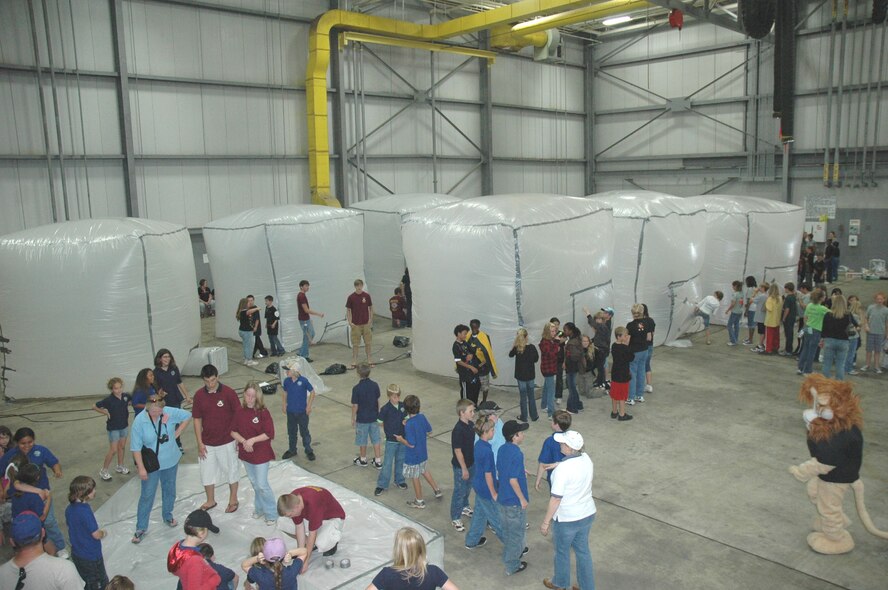 DUKE FIELD, Fla. -- Fifth-grade students from three area elementary schools transformed Duke Field's fuel cell hangar into a Martian habitat Friday during their Marsville event.  After hangar space at Eglin Air Force Base became temporarily unavailable, the 919th Special Operations Wing invited the program's host 96th Air Base Wing to use their hangar space.  More than 250 students, faculty and volunteers established a Martian base in the scientific project that challenged the youths' creativity and imagination in finding ways to colonize the Red planet with limited resources. (U.S. Air Force photo/Dan Neely)