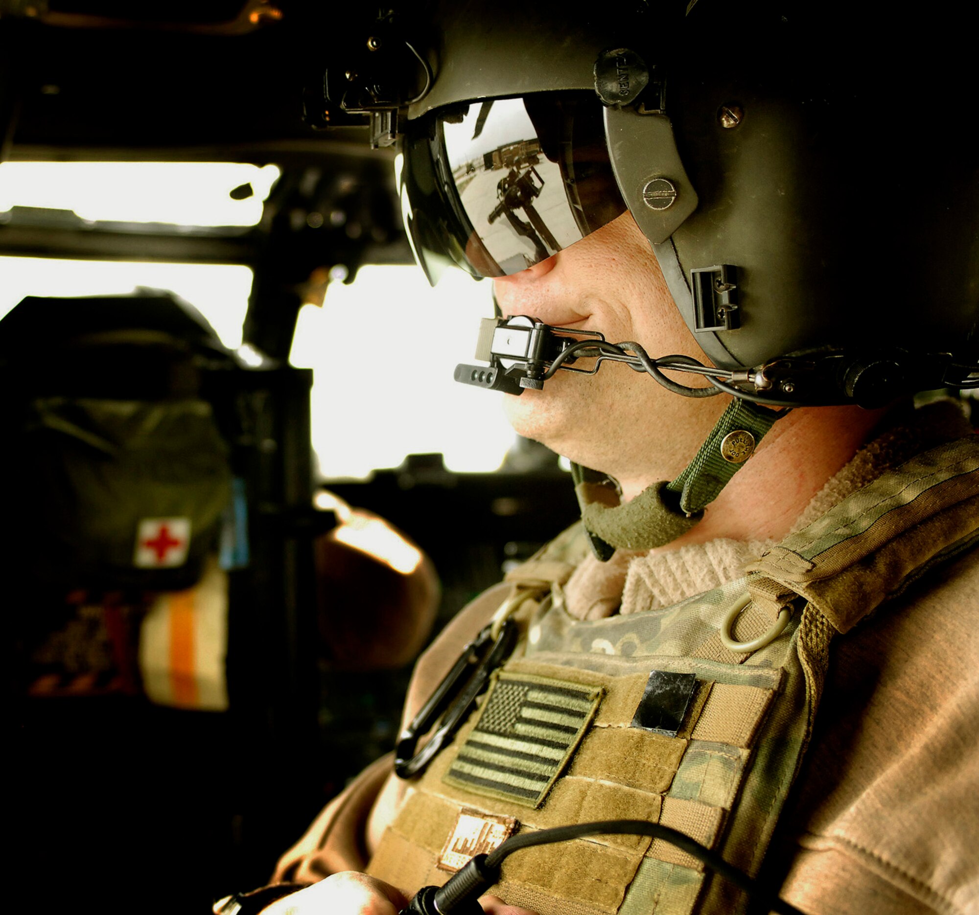 Senior Master Sgt. Glen Berg, 101st Expeditionary Rescue Squadron aerial gunner, mans his HH-60 Pave Hawk rail gun before taking off on a training mission here April 20. (Air Force/Staff Sgt. Jason Lake)