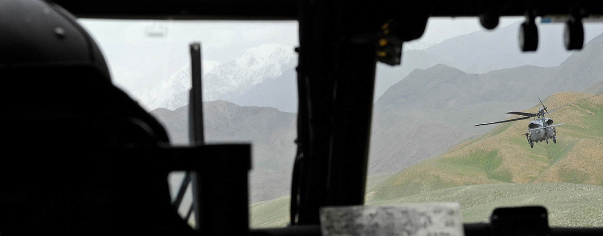 Capt. Tamar Hassan, 101st Expeditionary Rescue Squadron co-pilot, trails behind the lead HH-60 Pave Hawk during a training mission in Northeastern Afghanistan April 20. (Air Force/Staff Sgt. Jason Lake)