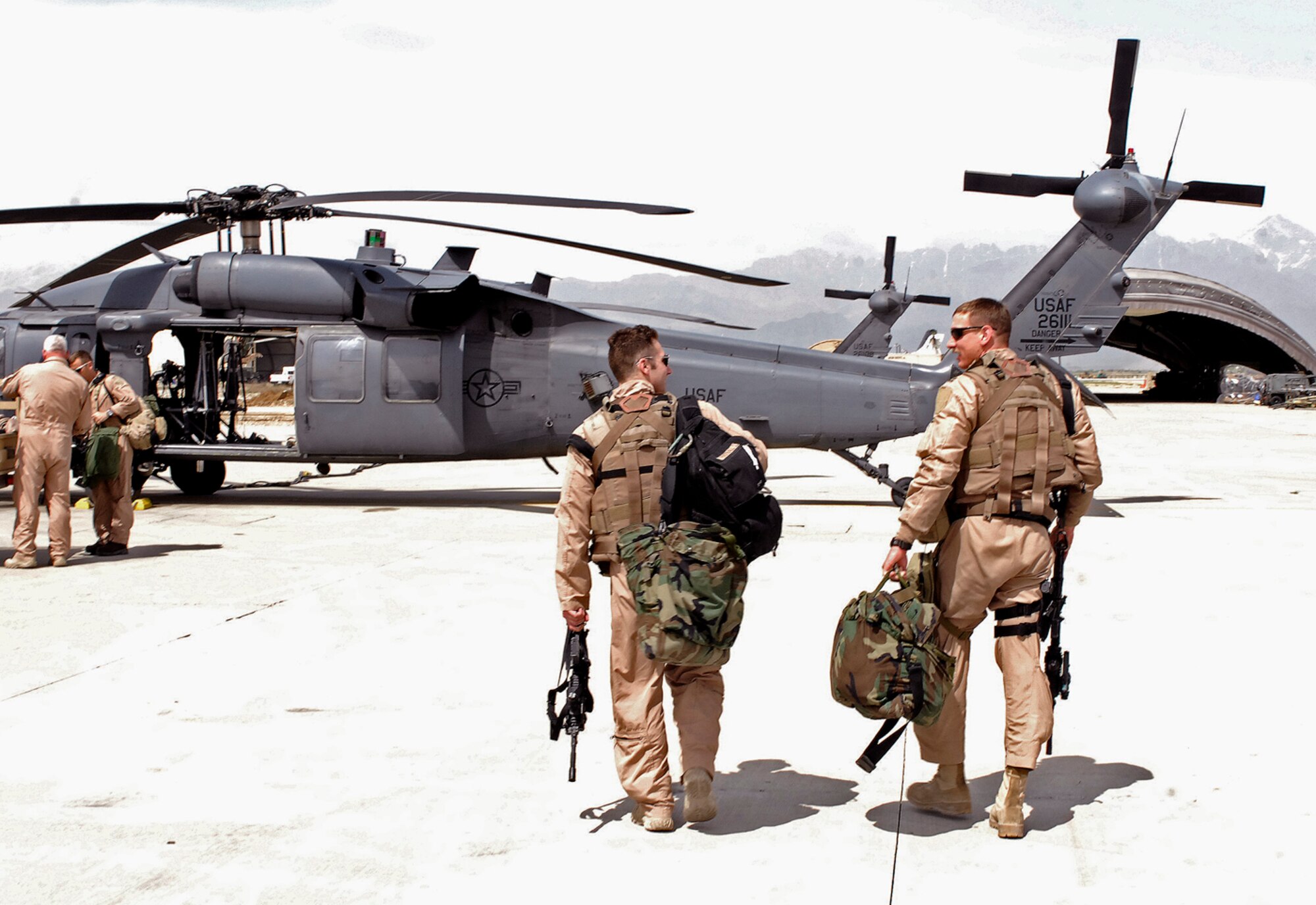 First Lt. Shaun Cullen, 101st Expeditionary Rescue Squadron pilot, and Capt. Robert Felix, 492nd Expeditionary Fighter Squadron flight surgeon, walk out to an HH-60 Pave Hawk prior to a training mission April 20. The 101st ERQS, deployed here from West Hampton Beach, N.Y., provides combat search and rescue capability for the 455th Air Expeditionary Wing. Nearly half of the New York Air National Guard aircrews deployed here are firefighters or police officers back home including Lieutenant Cullen. (Air Force/Staff Sgt. Jason Lake)