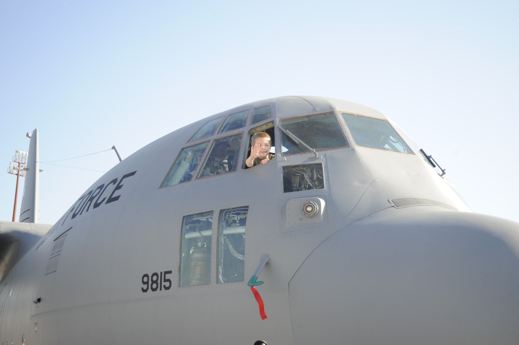 Jacob Jackson, a 5-year-old, waves to people from a C-130 Hercules during the first day of Airpower over Hampton Roads, a three-day airshow culmination of Air Force Week April 24 at Langley Air Force Base, Va. (Defense Department photo/Master Sgt. Ben Gonzales)
