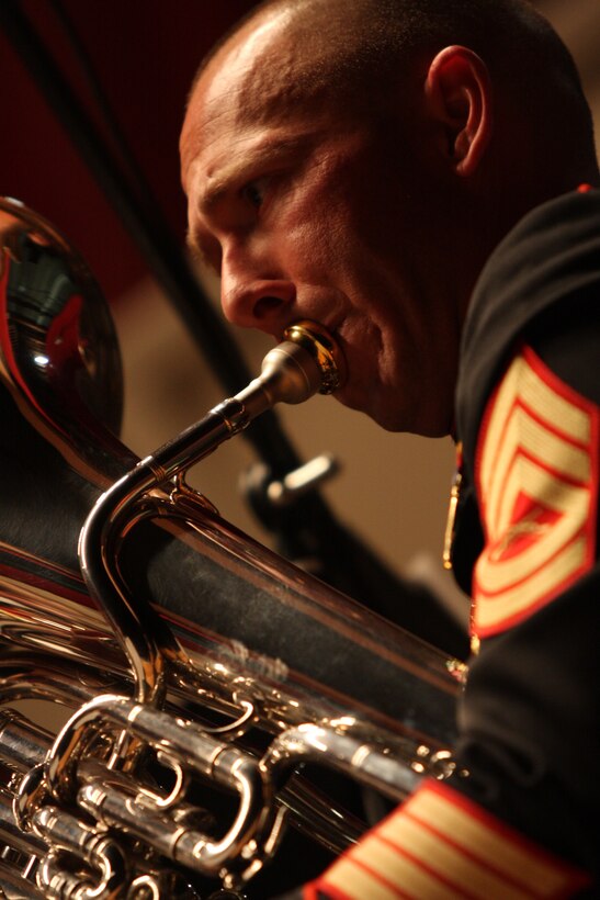 Gunnery Sgt. Carl Vanderzee, a tuba player with the Combat Center Band makes his instrument come to life during the Coats of Red and Blue 2 concert at the Sunset Cinema Sunday.