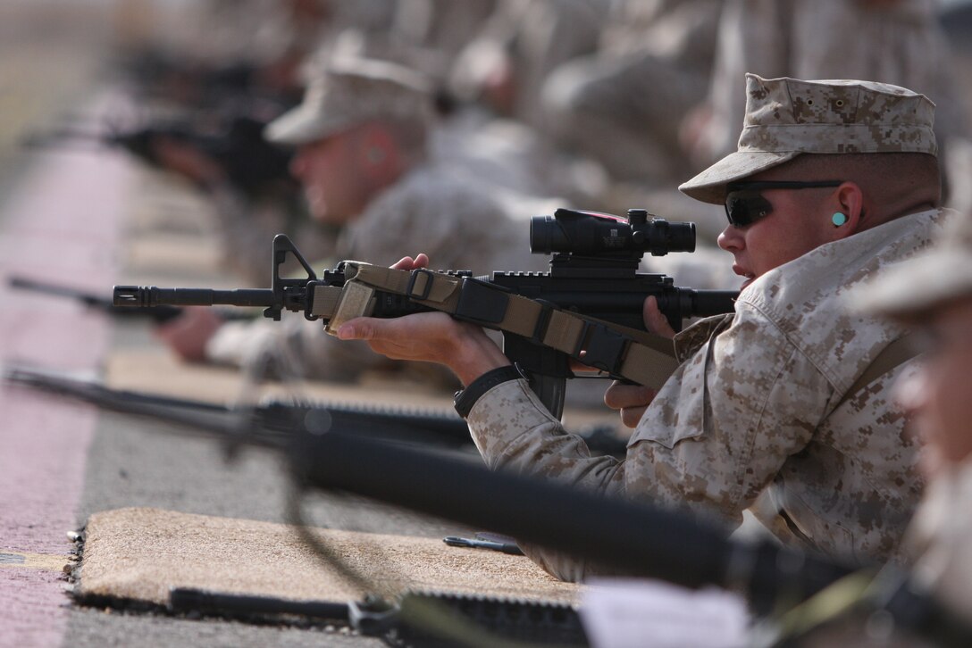 Cpl. Scott Riley, a student in the most recent Combat Marksmanship Coaches course, prepares to take a well-aimed shot at the Marksmanship Training Unit rifle range April 27.