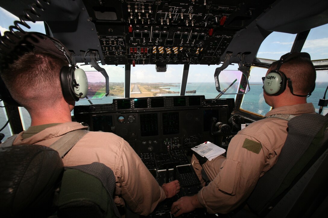 Lt. Col. Robert Cote, left, Marine Aerial Refueler Transport Squadron 252's commanding officer, and Capt. Chad Magro, KC-139 pilot, approach the runway in Grenada, April 26. Six VMGR-252 Marines participated in a mission to return a piece of aircraft lost during Operation Urgent Fury to Quantico, Va.