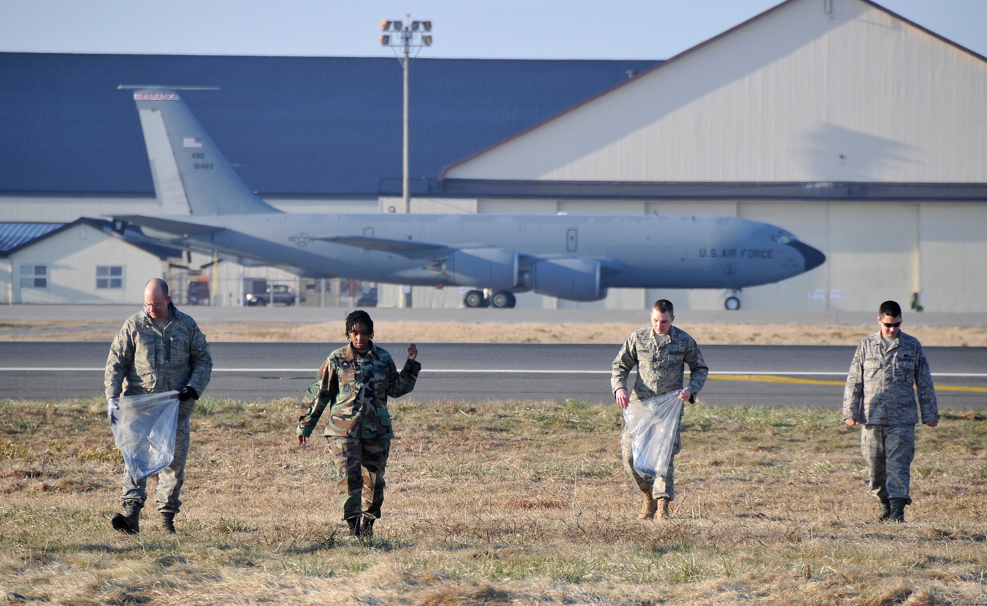 MISAWA AIR BASE, Japan -- Misawa Airmen pick up foreign objects on the airfield during the annual fighter wing foreign object damage walk April 17, 2009. Approximately 600 Airmen picked up FOD over a span of three miles.  (U.S. Air Force photo by Senior Airman Chad C. Strohmeyer)