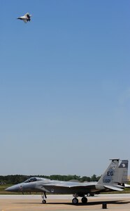 LANGLEY AIR FORCE BASE, Va. -- Maj. Dave Skalicky, F-22A Raptor Demonstration Team pilot, flies over an F-15 Eagle for a dedication pass to the F-15 West Coast Demo Team at AirPower Over Hampton Roads April 26.  The F-22A Raptor Demo Team and the F-15 West Coast Demo Team were featured at Langley's open house.  This weekend was also the final flight for the F-15 West Coast Demo Team after 26 years of performances. (U.S. Air Force photo/Airman 1st Class Zachary Wolf)
